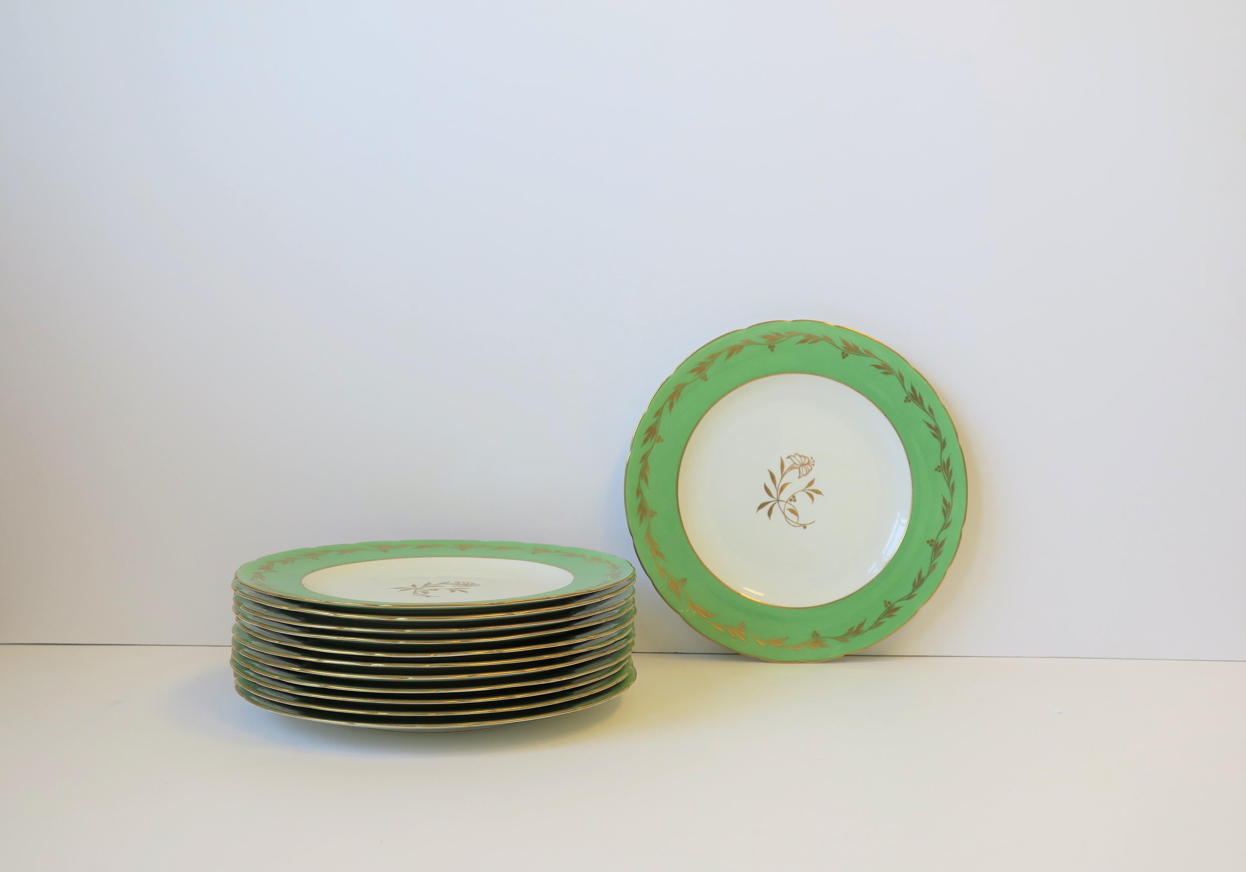 A beautiful set of 12 dinner plates made by Royal Crown Derby exclusively for iconic Tiffany & Co. New York, circa early-20th century, England. Plates are decorated with 22-karat gold, border in a 'spring' green or 'Kelly' green and gold leaf