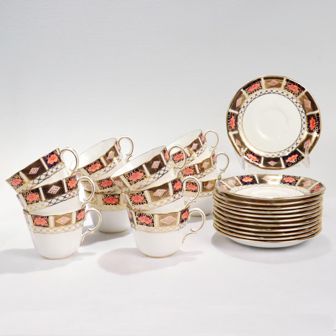 A fine set of 12 Royal Crown Derby porcelain cups & saucers

In the Border Imari pattern (No. 8450)

Consisting of 12 cups and 12 saucers all with scalloped rims, gilt highlights, and imari designs to their borders.

Marked to the base of each with