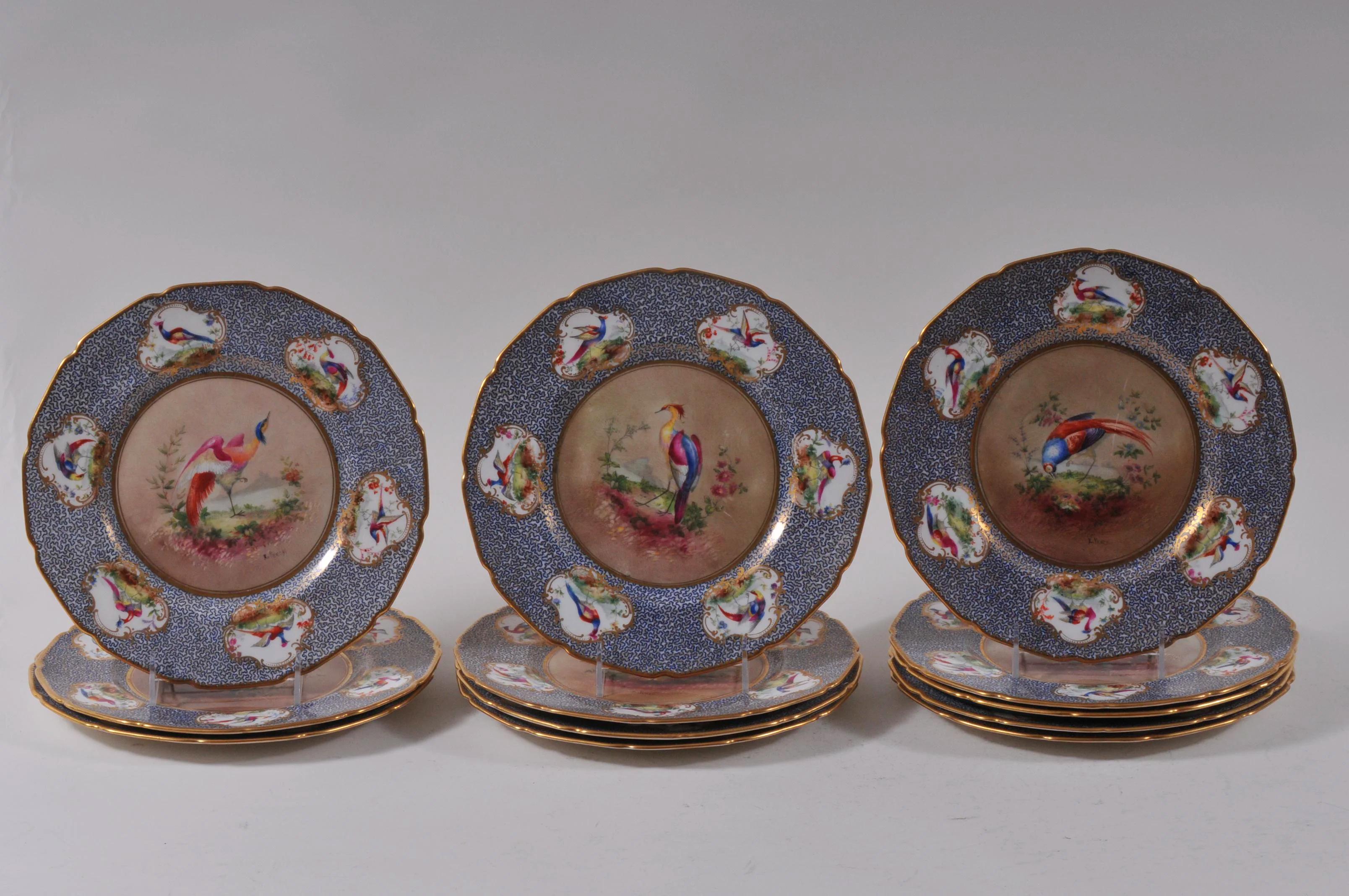 Set of twelve (six pairs) of Royal Doulton fine quality hand painted porcelain game plates decorated by E. Percy, dating from 1914. All-over decorated borders with six medallions of the game birds featured on the plate interiors. Ten are artist