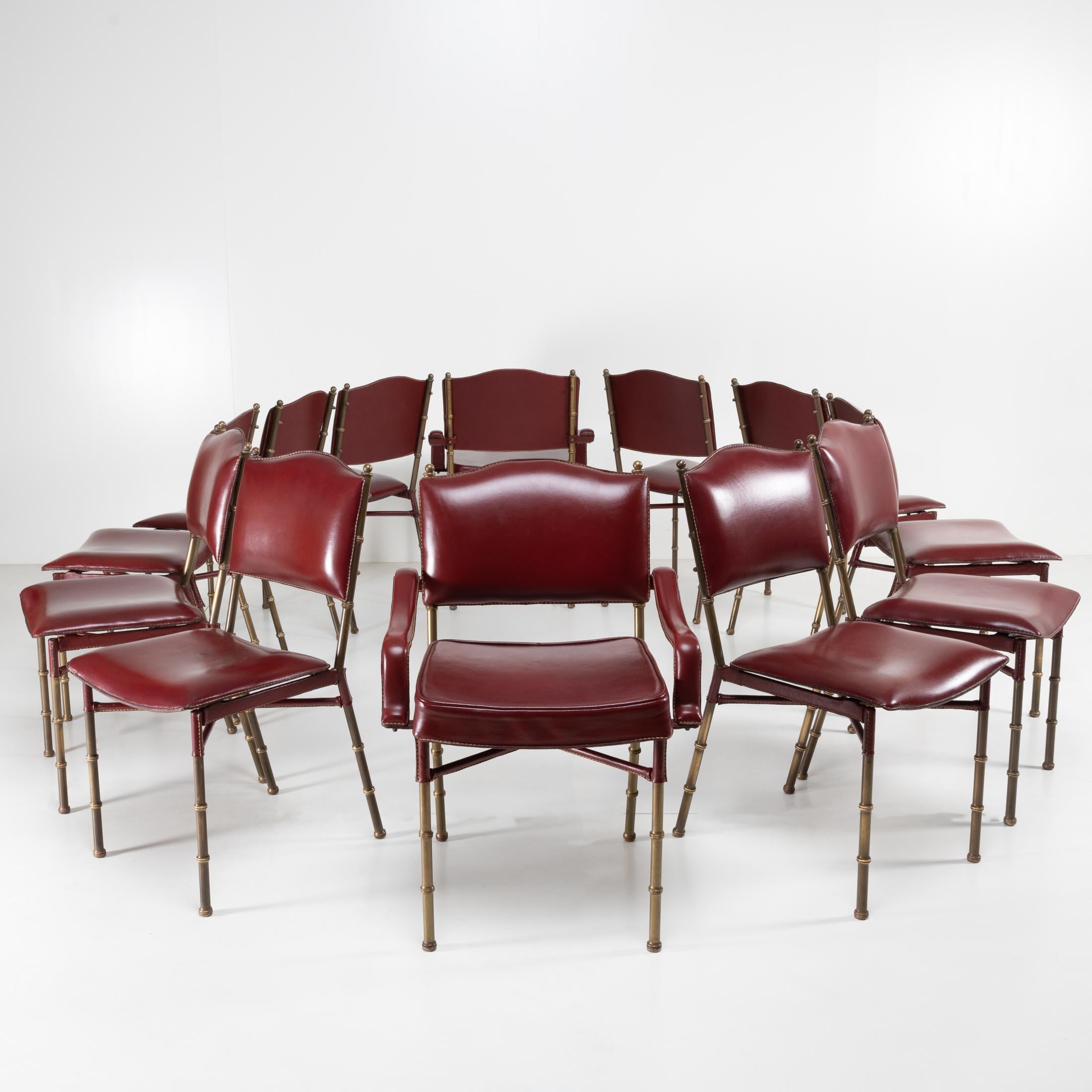 About this set of 12 chairs by Jacques Adnet
A rare set of 12 red leather saddle stitch chairs.
Composed of 10 chairs and 2 armchairs with steel armrests covered in leather. The chairs and the 2 armchairs consist of a steel structure covered in