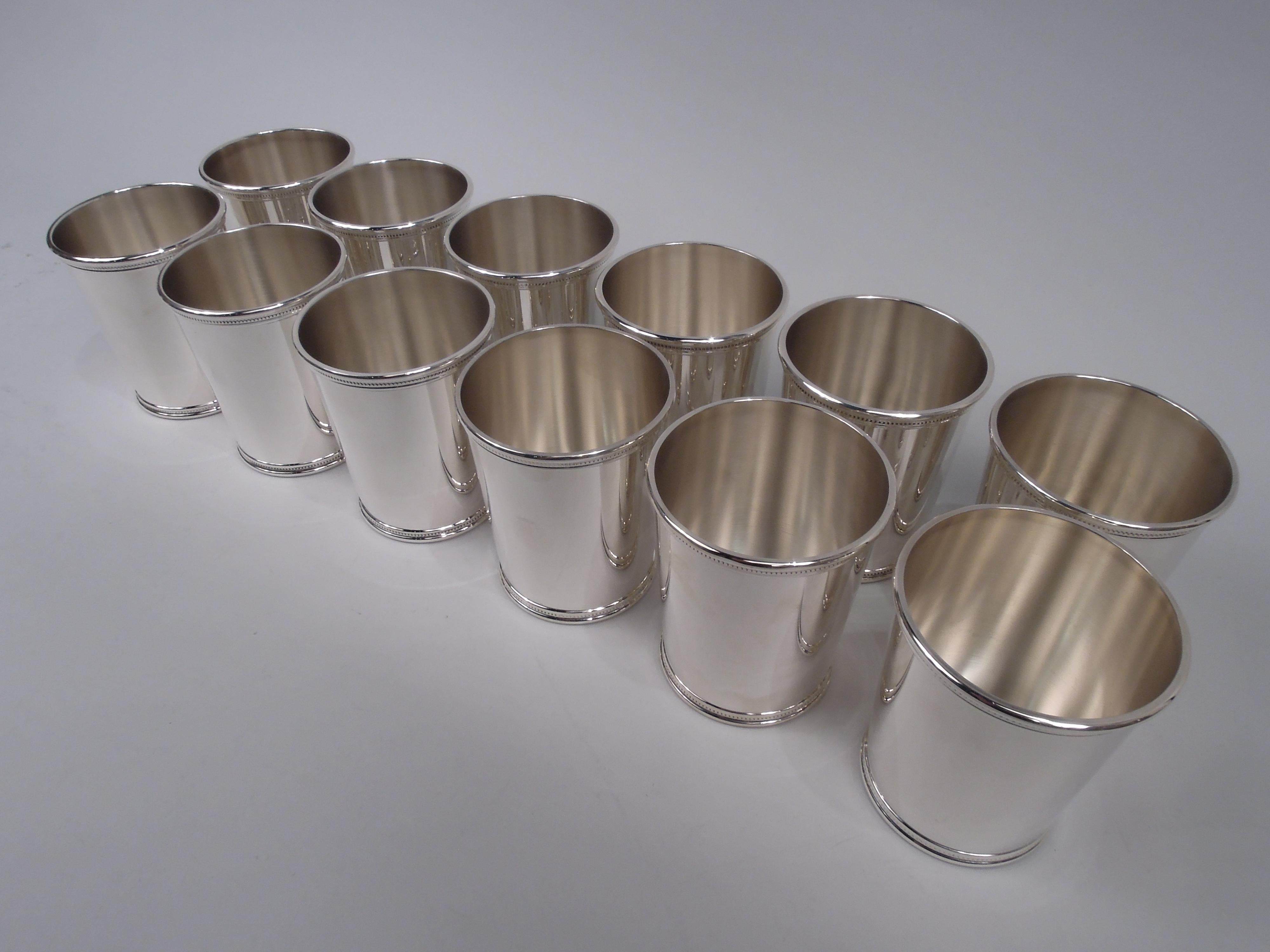 Twelve sterling silver mint juleps. Made by Scearce in Shelbyville, Kentucky. Each: Straight and tapering sides, and beaded and molded rim and foot. A great Nixon-era set comprising 8 cups from the Silent Majority first term and 4 from the embattled