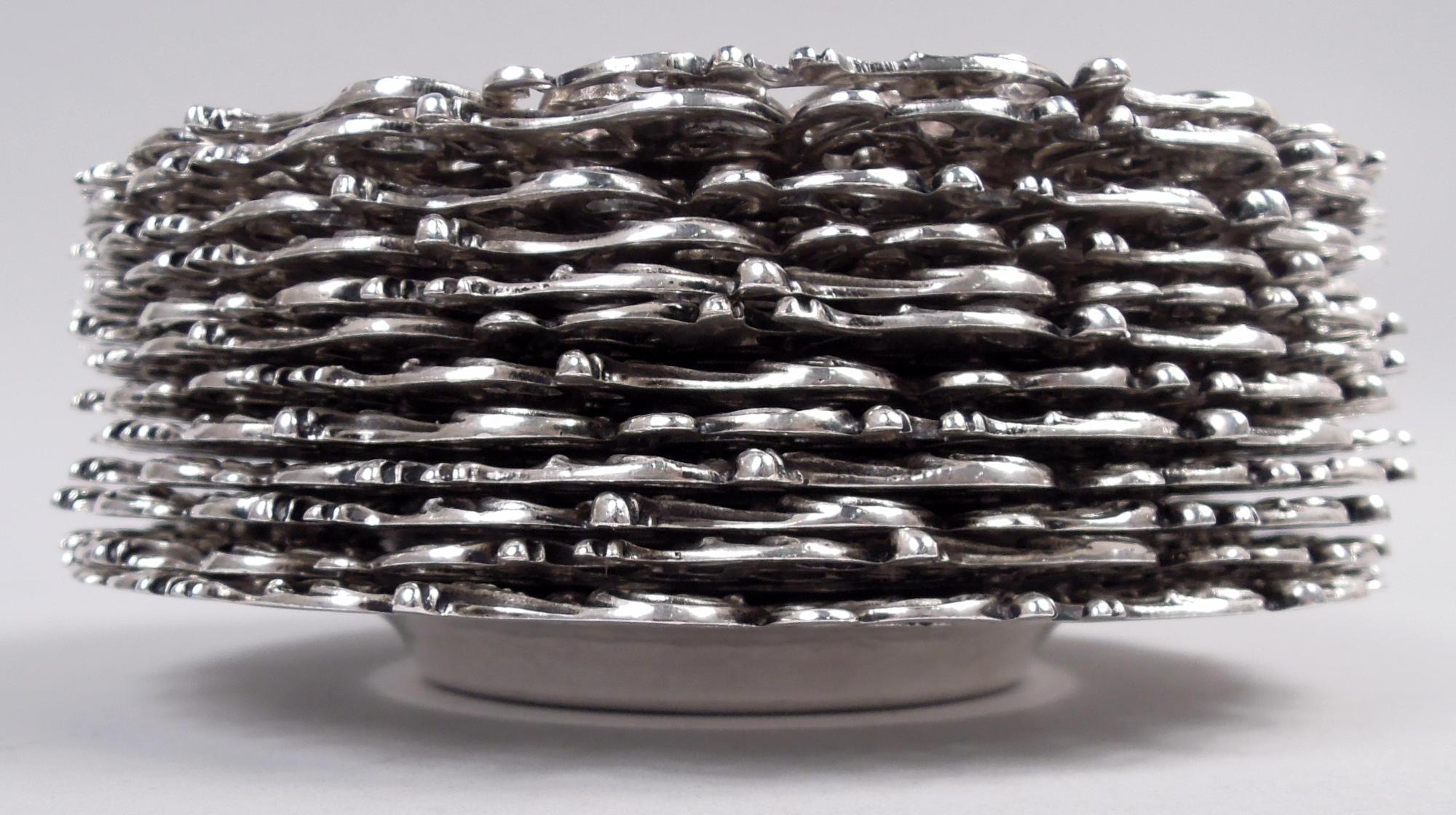 Set of 12 American Victorian Classical sterling silver bread and butter plates, ca 1890. Each: Deep well engraved with interlaced script monogram surrounded by leafing scrollwork and flowers. Wide and cast open rim with same. Fully marked including
