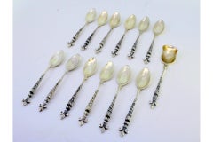 Set of 12 silver teaspoons & sugar shovel with fleur-de-lis accents