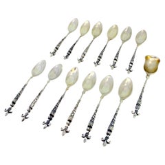Set of 12 silver teaspoons & sugar shovel with fleur-de-lis accents