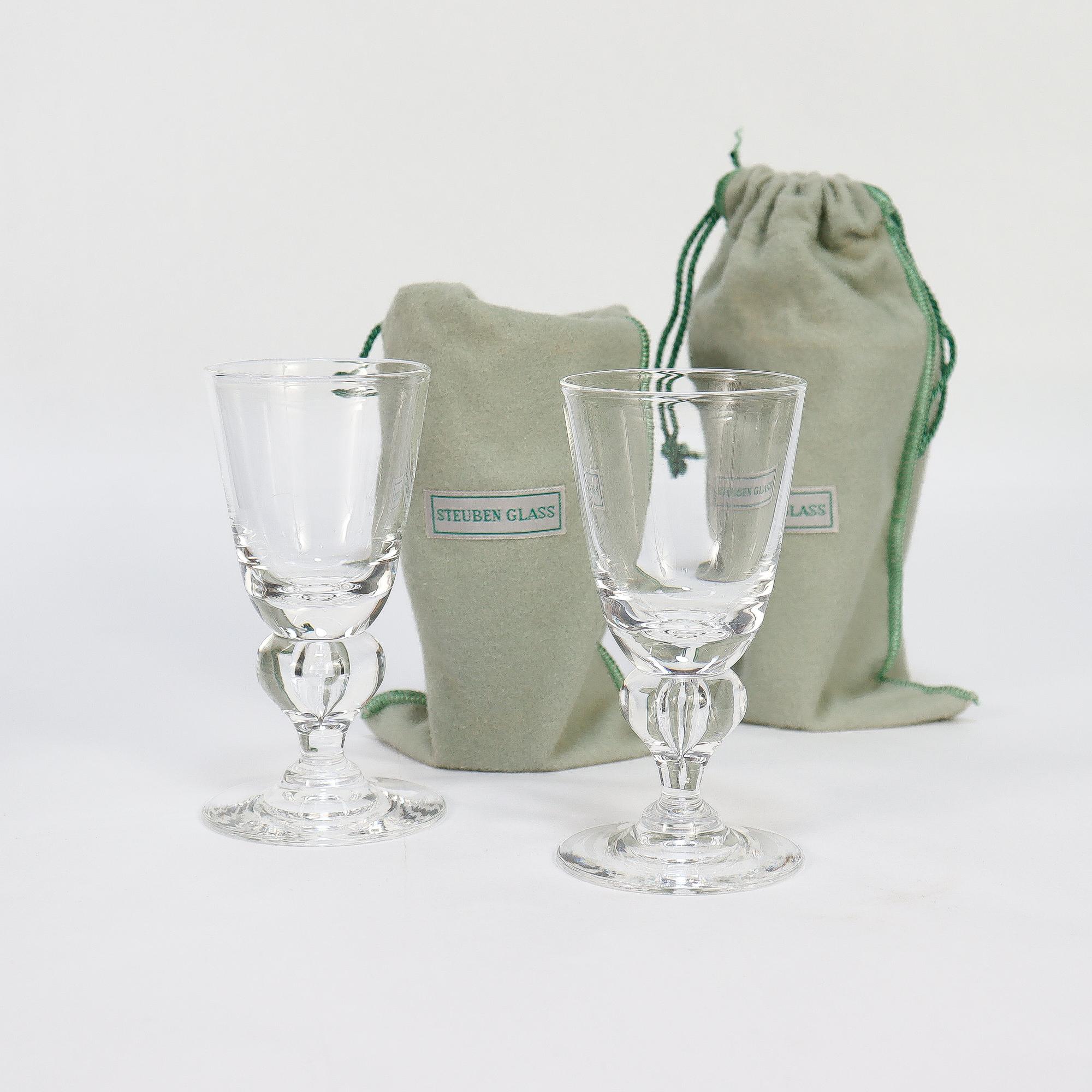 A fine set of cordials glasses or stems.

By George Thompson for Steuben.

In clear glass. 

Pattern No. 7877.

Each cordial with a round foot and a baluster stem with a teardrop air bubble trapped inside. Holds about 2 oz.

Together with the