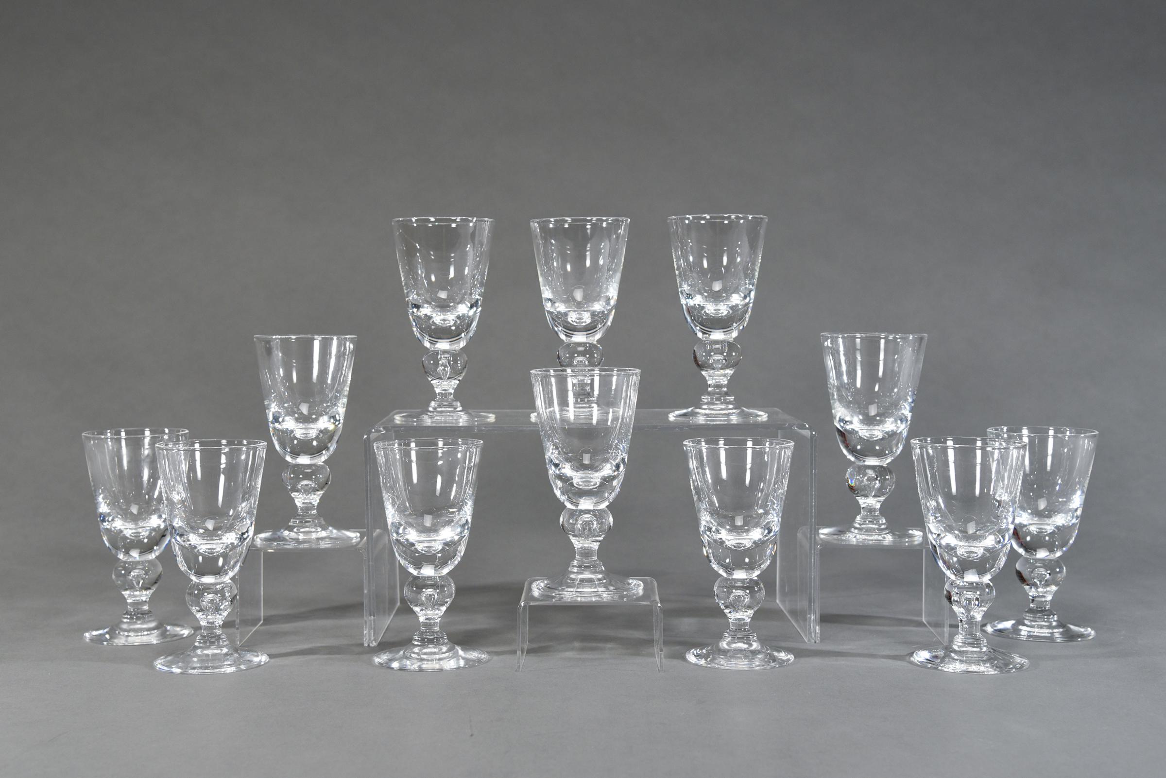 One of the most desirable patterns of Steuben's clear stemware services is this Classic baluster shaped goblet, pattern # 7877, designed by George Thompson. Hand blown crystal with a low center of gravity, it is the perfect weight, which feels