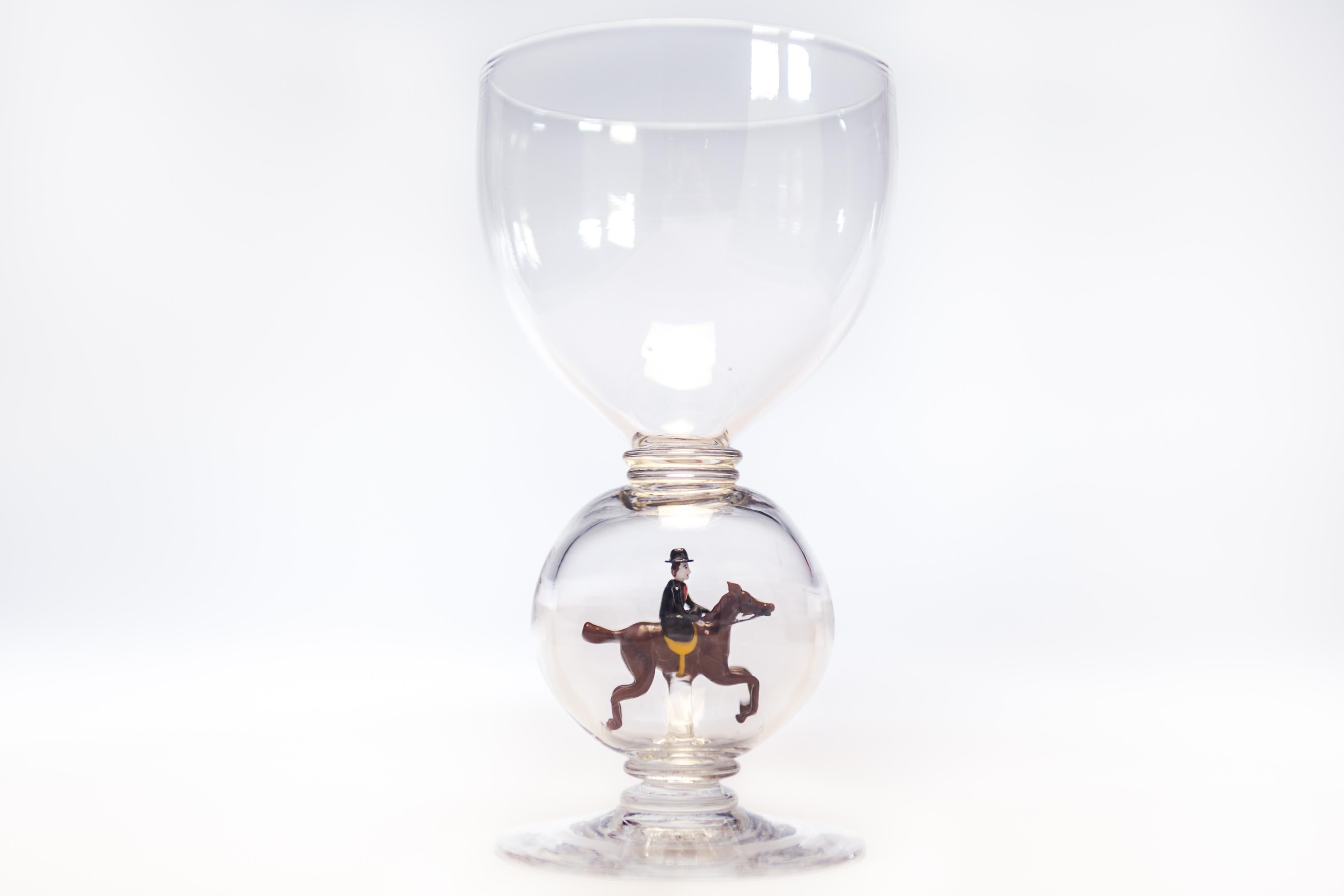 This set of 12 hand blown crystal goblets large goblets were made in England by Stevens and Williams, circa 1910. Each one features a unique figural bubble connector depicting a different hunt theme. The figures are all hand blown lamp work hunt