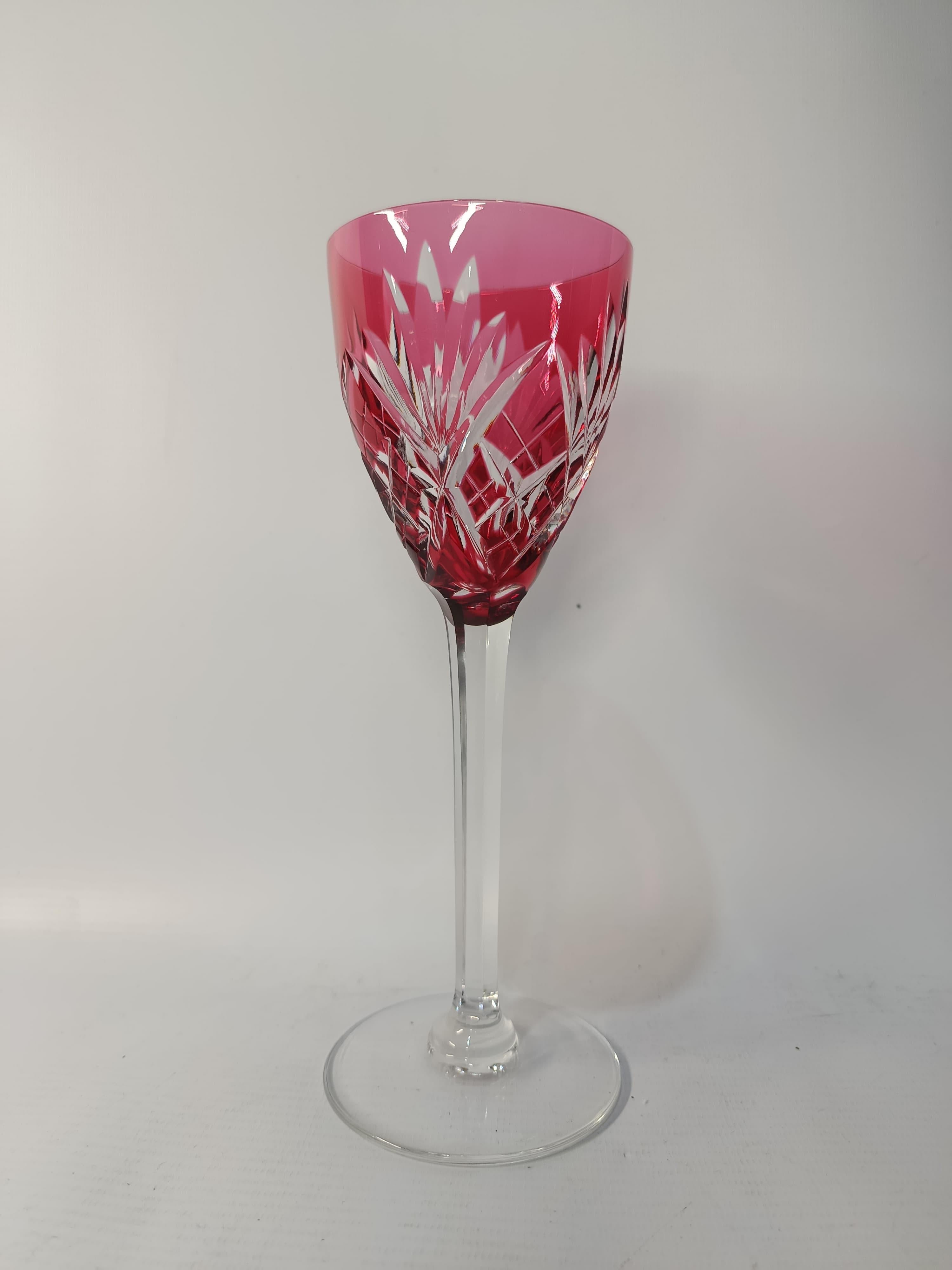 This exquisite set of 12 tall red crystal wine glasses is an exceptional example of timeless French craftsmanship. Dating back to circa 1940, each glass is finely made of deep ruby crystal and displays a refined, classic style associated with the