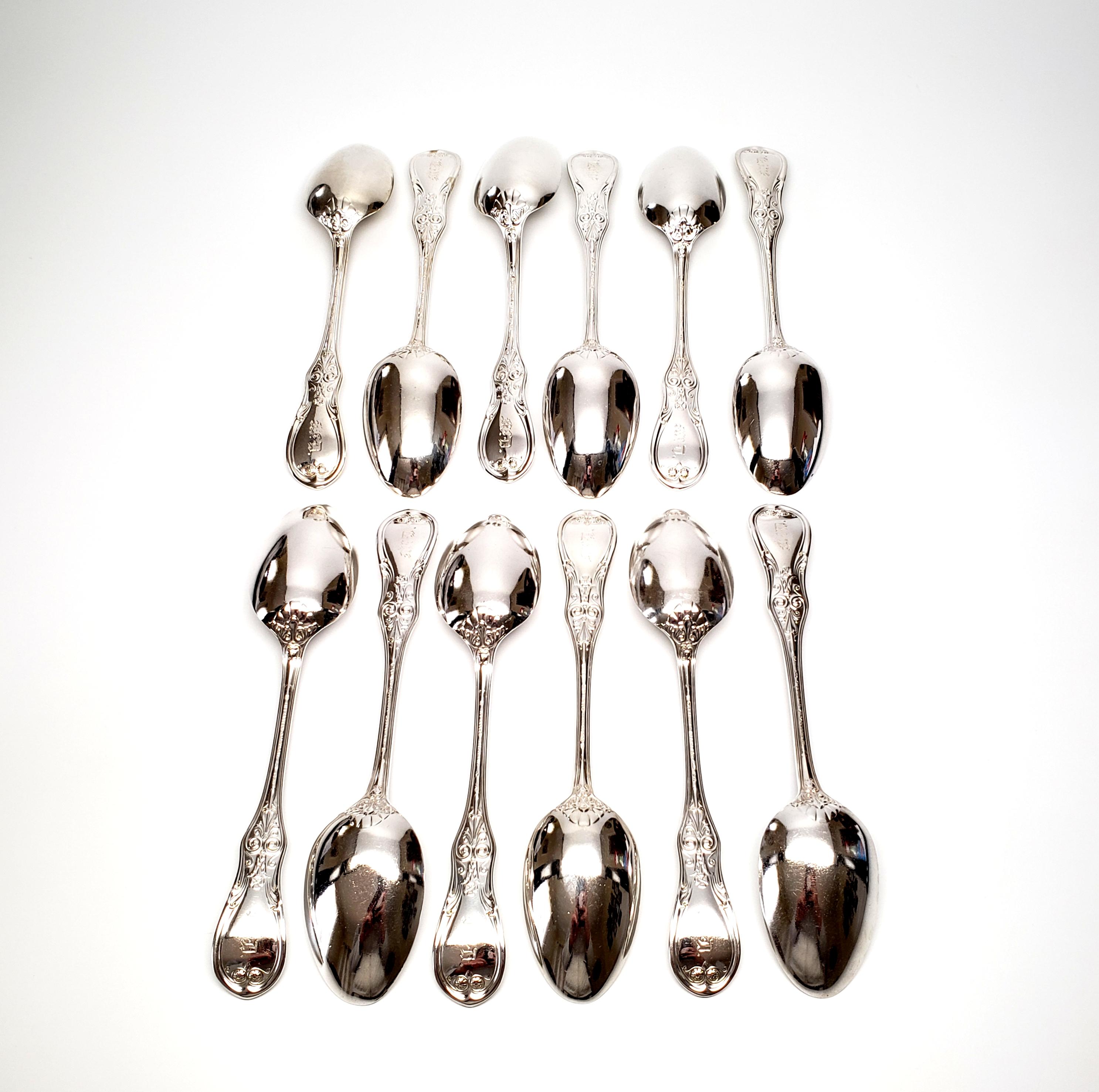 Set of 12 antique sterling silver teaspoons by Tiffany & Co in the Saratoga/Cook/King pattern, c.1912.

Monogram appears to be McD - fading

Beautiful spoons with an oval bowl. This pattern was first introduced as Kings in 1870, was reintroduced