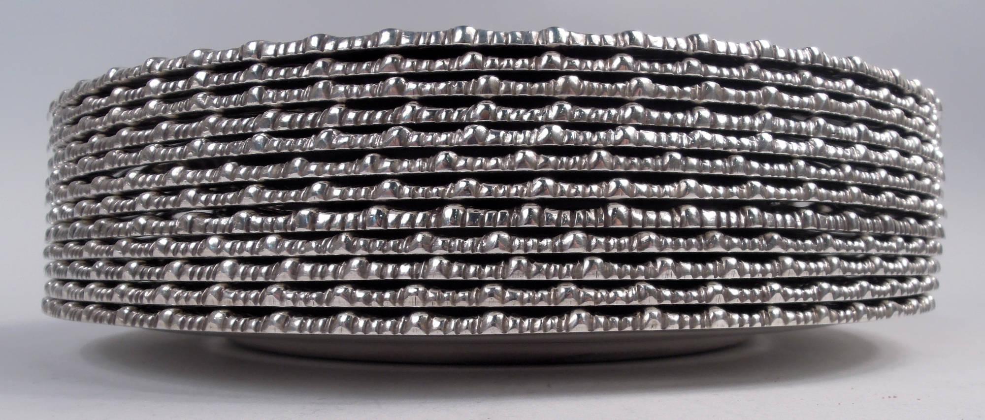 Set of 12 Edwardian Georgian sterling silver dinner plates. Made by Tiffany & Co. in New York, ca 1915. Each: Round well and wide shoulder with cabled border and cast foliate gadrooned rim. Fully marked including maker’s stamp, pattern no. 18887