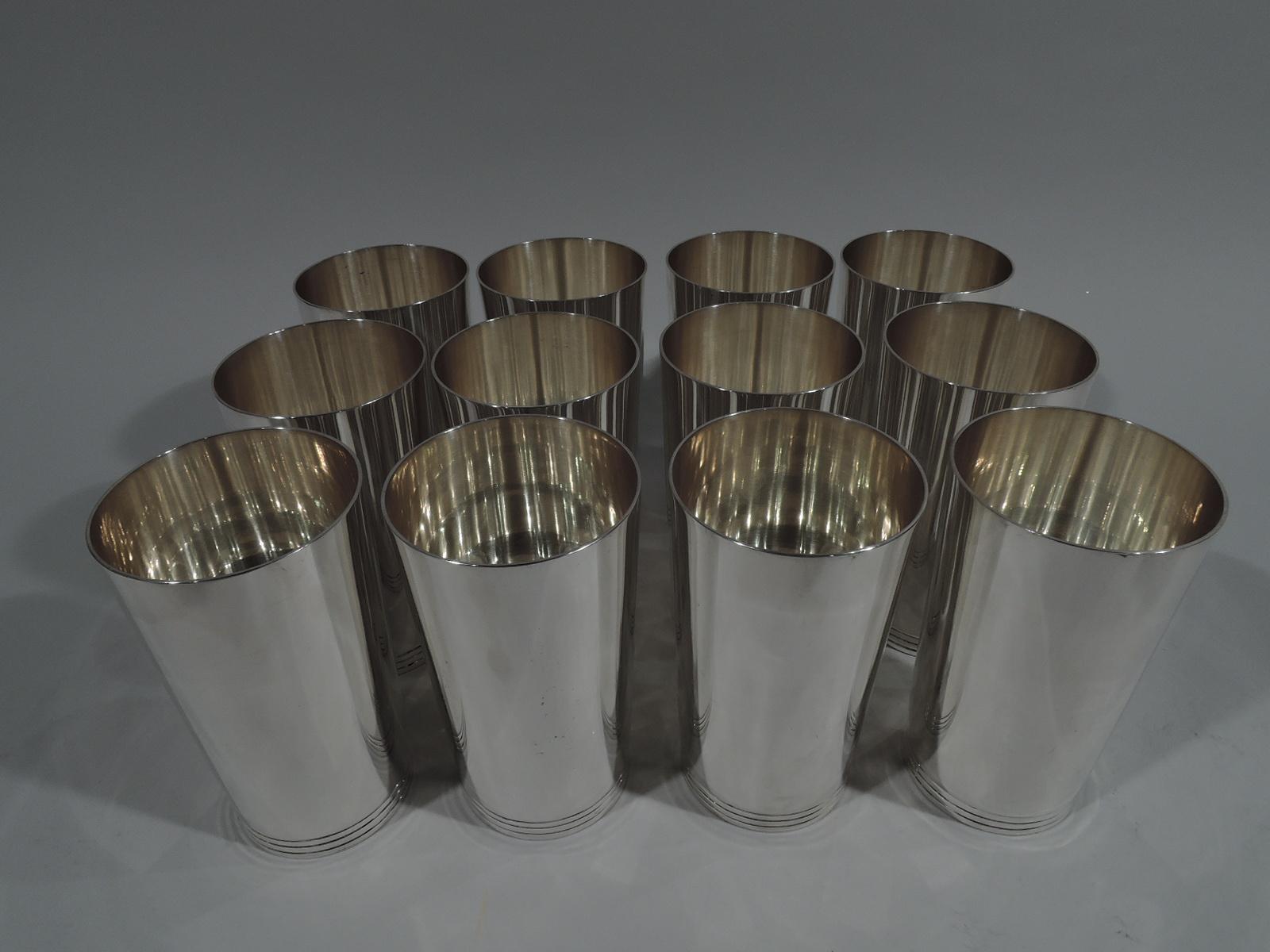 Set of 12 fabulous Art Deco sterling silver highballs. Made by Tiffany & Co. in New York. Each: Cylindrical with curved bottom. Clean and spare with incised bands at base. Easy-grip size for knocking ’em back. Fully marked including pattern no.