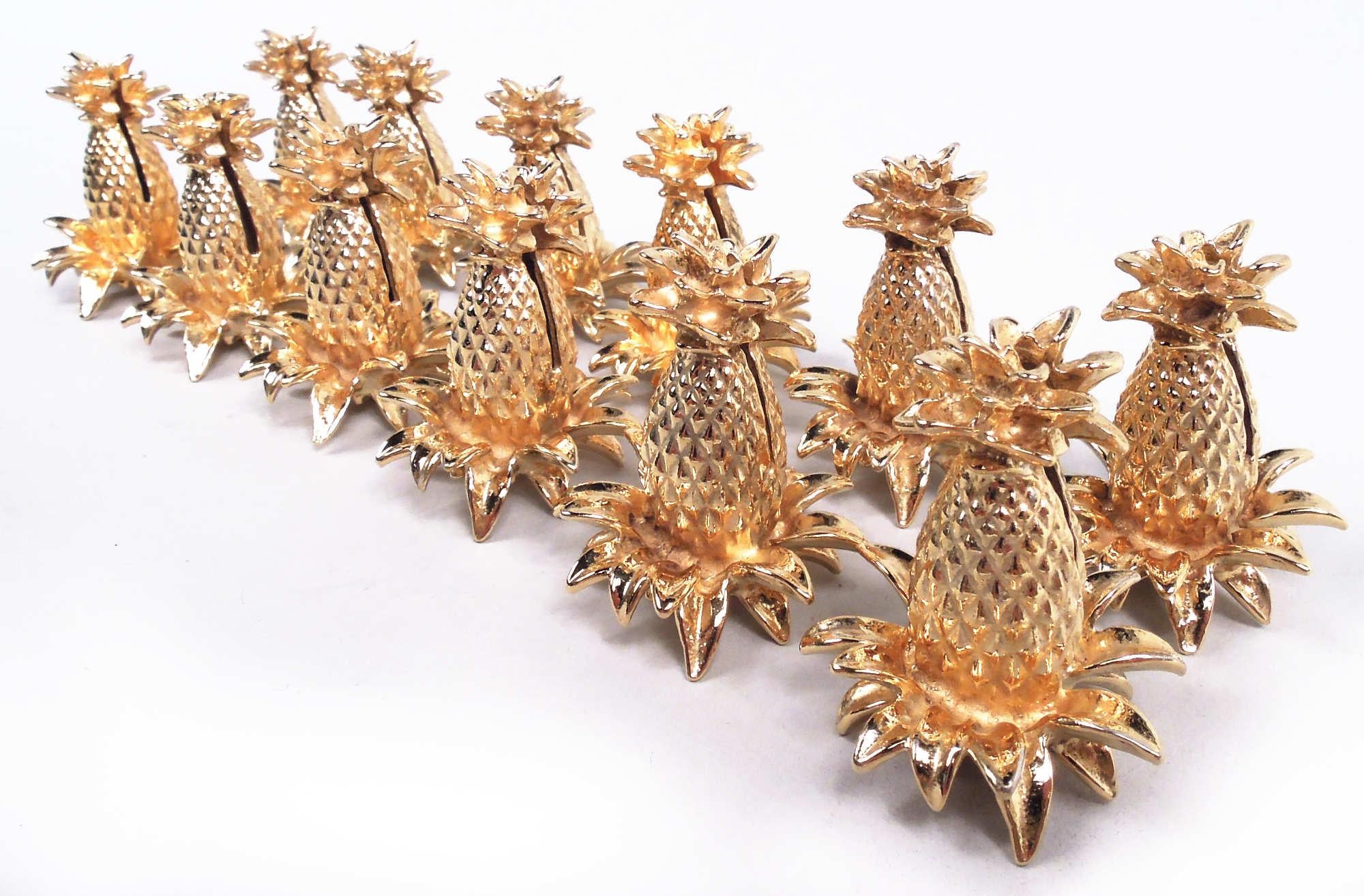Set of 12 Modern cast sterling silver figural fruit place card holders. Each: Pineapple with nubby skin and flamboyant crown and leaves. Rich and showy gilding. Marked “Tiffany & Co. / Sterling”. Total weight: 10 troy ounces. 