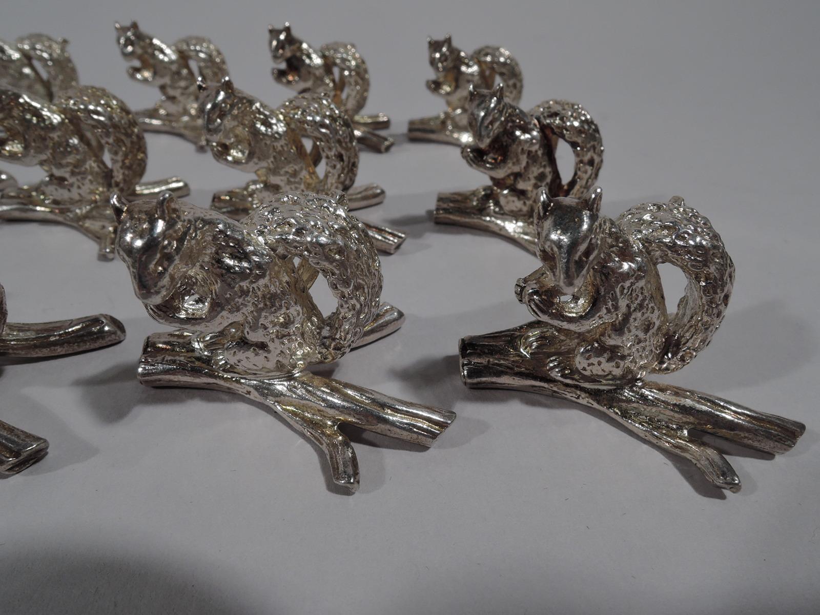 Set of 12 sterling silver place card holders. Retailed by Tiffany & Co. in New York. Each: A squirrel with bushy tail and wary glance grips an acorn with tensile forepaws. An impudent guest for your next dinner party. Squirrel is mounted to a twig