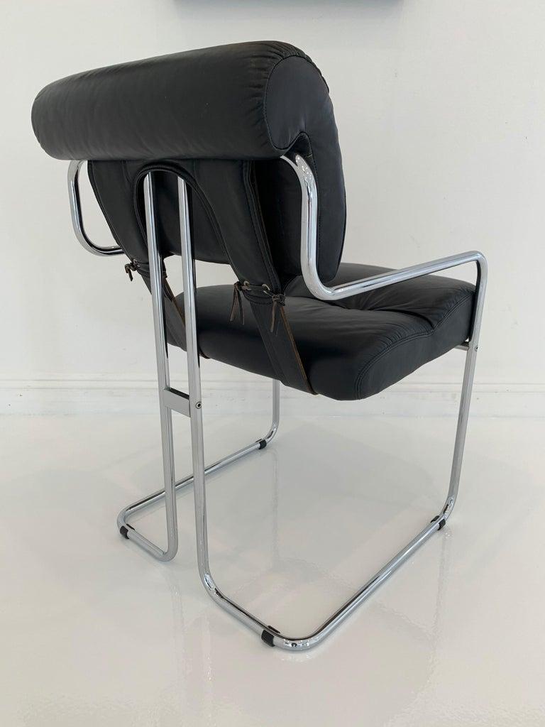 Classic leather chairs by Guido Faleschini for Pace/Mariani. Tubular chrome chair with black leather upholstery and black leather straps connecting seat back with seat bottom. Good condition with wear as shown. Great color and patina. Extremely