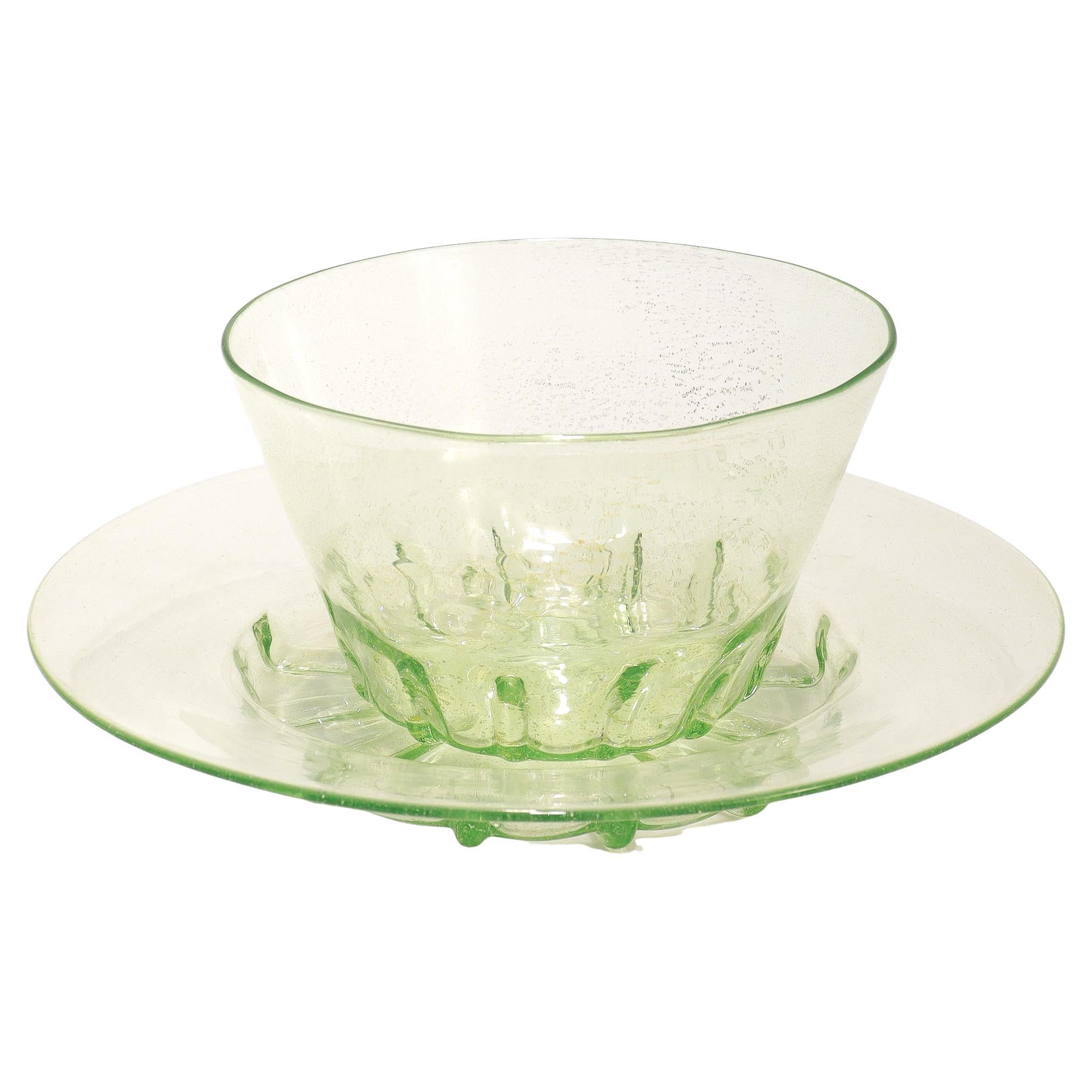 A fine, large set of Venetian glass bowls and underplates.

Attributed to Salviati.

In lime green (almost uranium colored) glass with gold foil inclusions throughout.
 
With crimping to the base of the bowls and plates.

Simply wonderful Murano