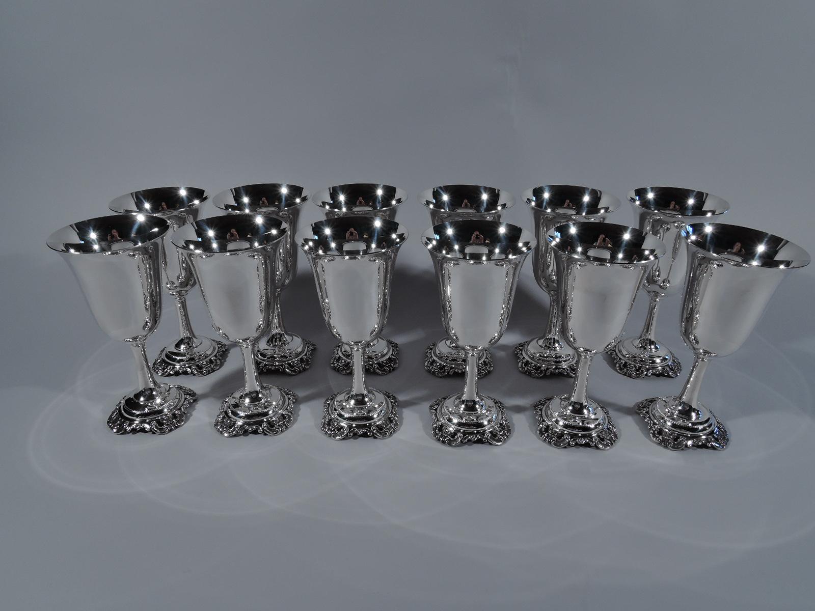 Set of 12 Grande Baroque sterling silver goblets. Made by Wallace in Wallingford, Conn. Each: Bell-form bowl on cylindrical stem on beaded and domed foot applied with open scroll and flower rim. Perfect for a special dinner in the cherished pattern