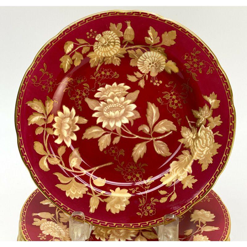 Set of 12 Wedgwood England Porcelain dessert plates in Tonquin Ruby, circa 1930

12 Wedgwood England porcelain 8 inch dessert plates in Tonquin Ruby, circa 1930. A ruby red ground with gilt floral designs and a Greek Key boarder to the scalloped