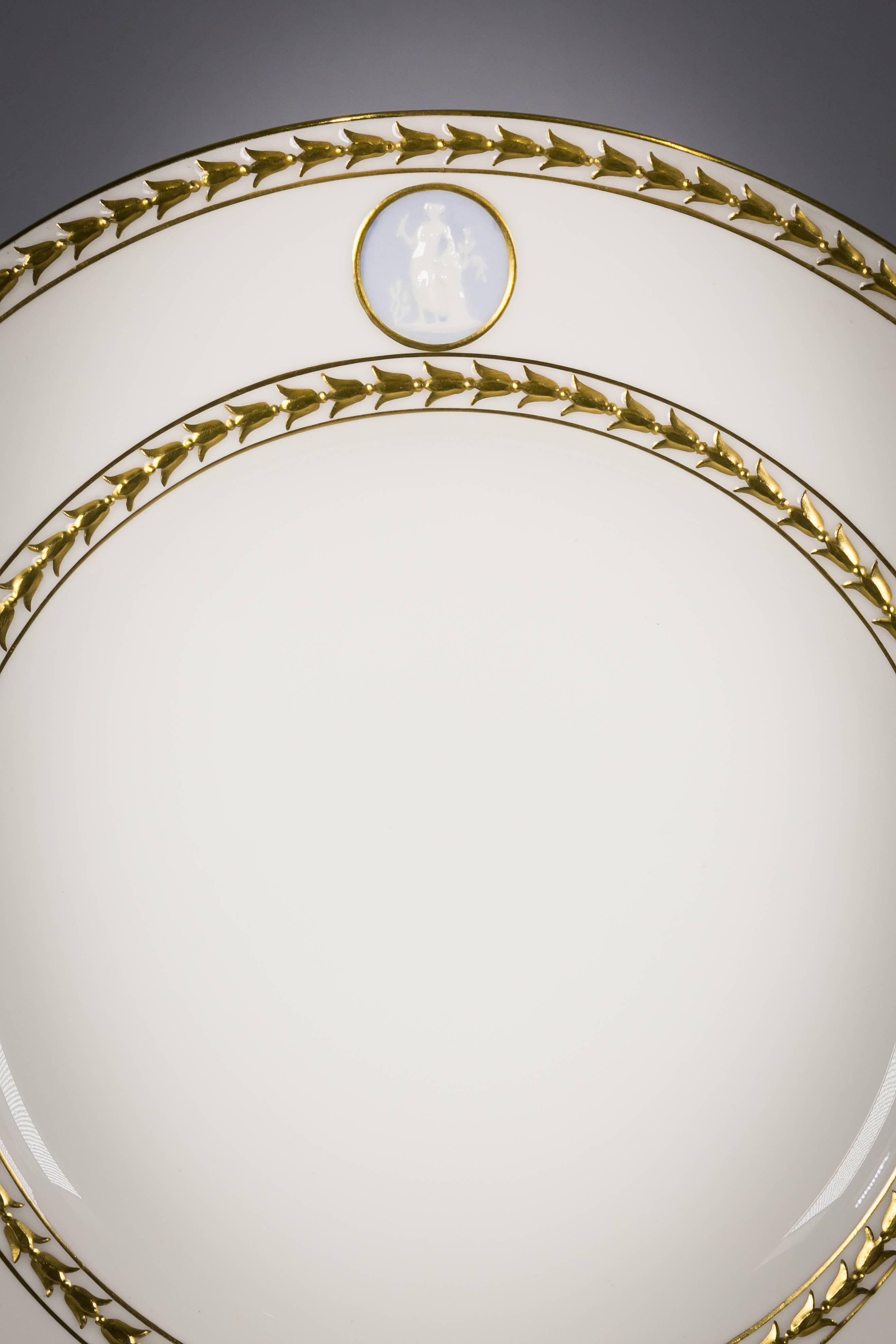 With roundels of molded neoclassical figures on a blue jasper colored background.