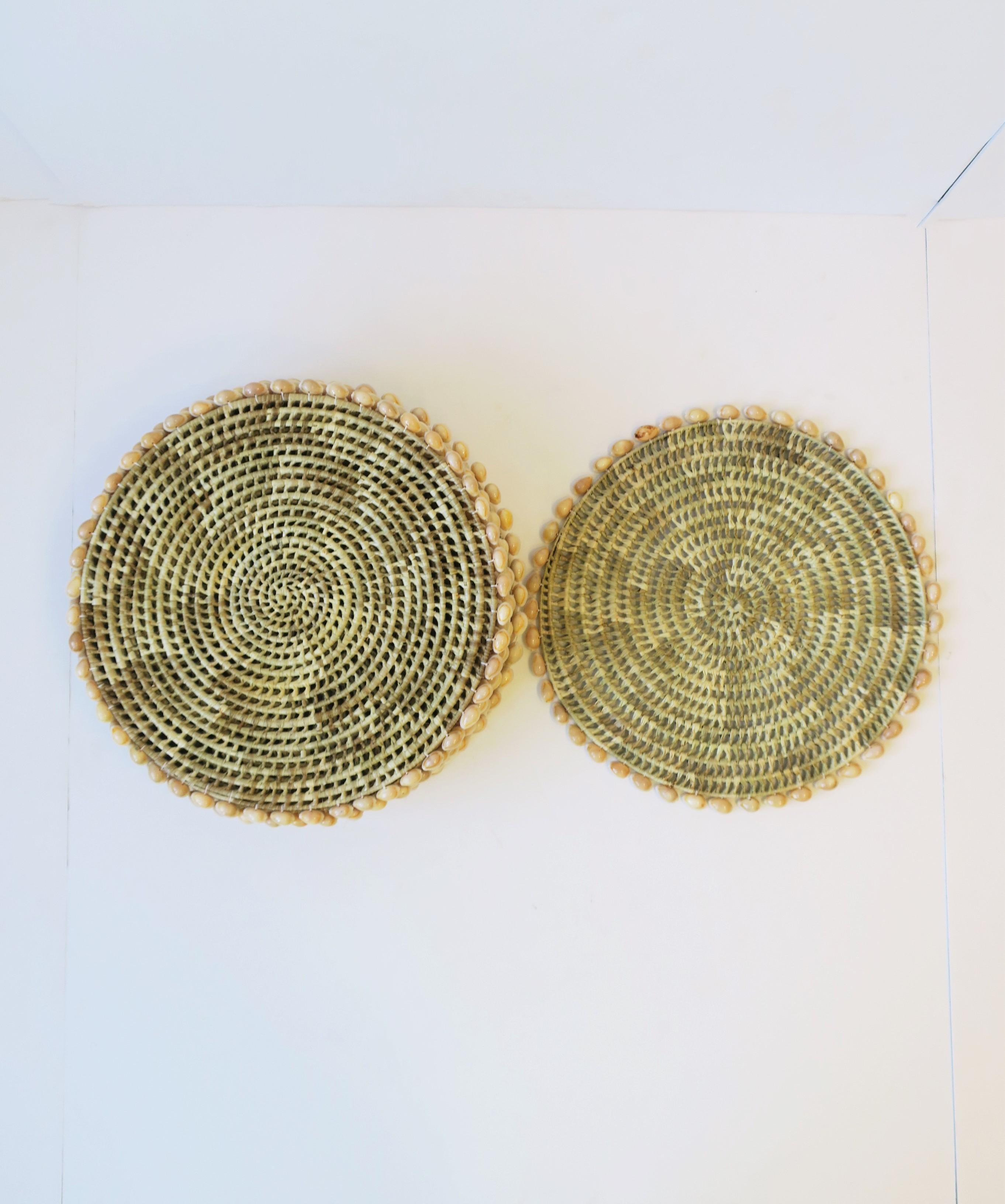 A beautiful set of twelve (12) round wicker and seashell placemats or dinner plate chargers. Seashells outline the wicker placemat / plate charger. A great set for summer, holiday, home, yacht, entertaining, etc., indoors or out. Dimensions: 15