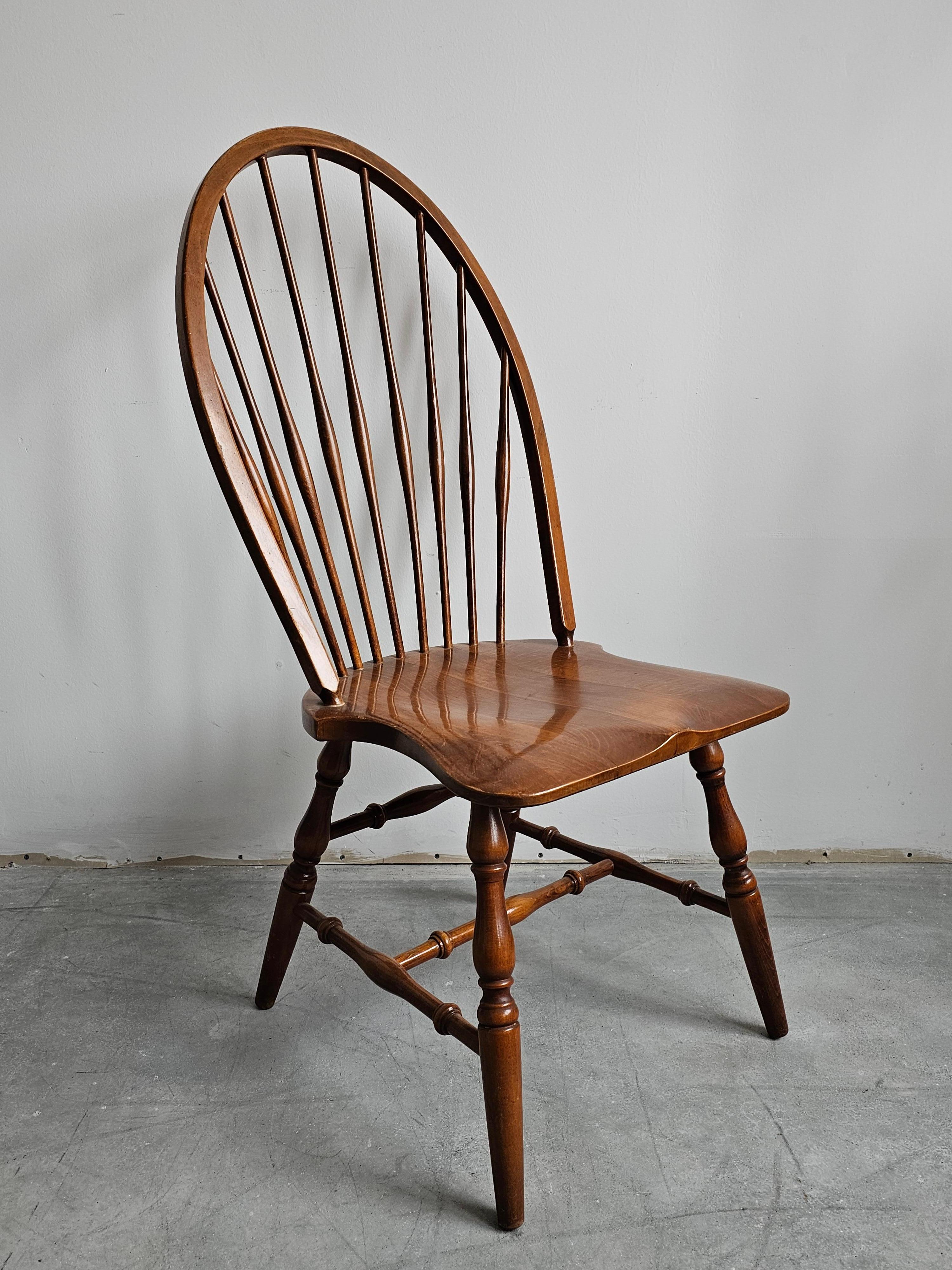 In this listing you will find a set of 12 Windsor dining chairs and armchair done in solid Beech 8 chairs with and 4 chairs without armrests, manufactured in Yugoslavia in 1950s. 

They feature tall spindle back, making it one of the rarest models