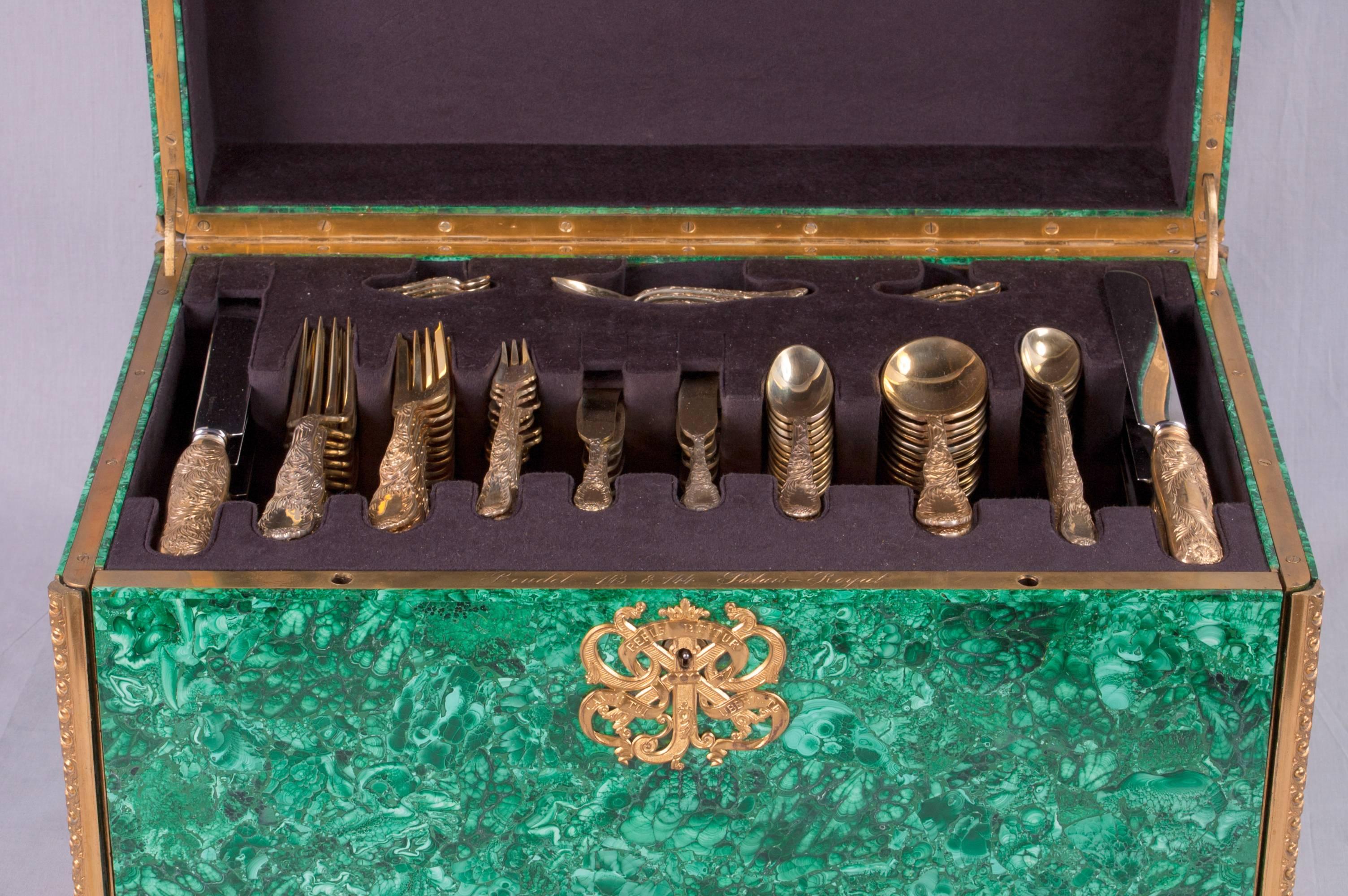 Set of 120-piece Tiffany Gilt Chrysanthemum flatware is nested in a converted malachite and bronze dore fitted chest that was formerly a necessaire travel case, signed Boudet.
The chest was made earlier than the sterling, circa 1840 and certainly
