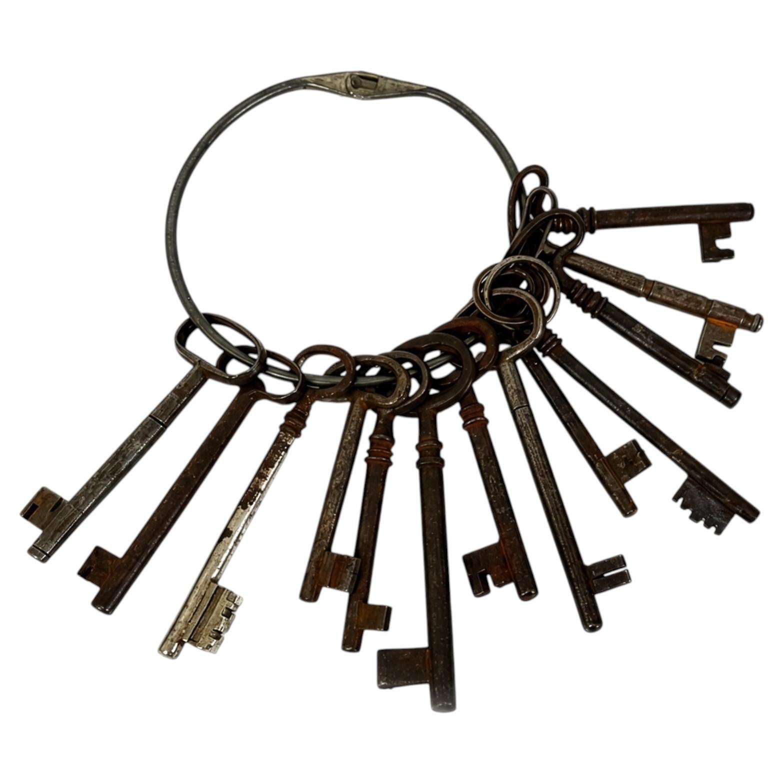 Set of 13 Antique Iron Skeleton Keys on Keeper’s Ring, circa 1900 For Sale