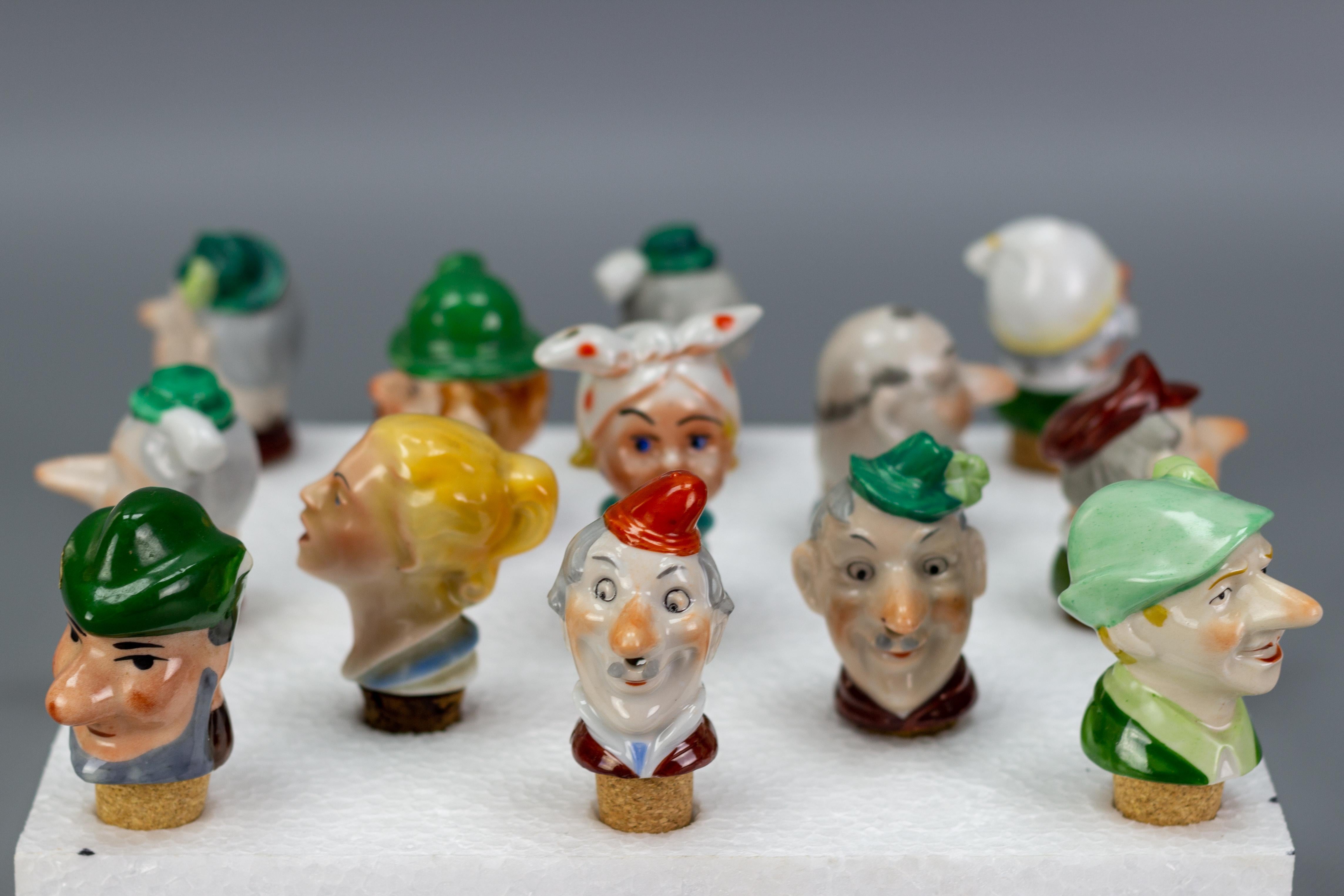 Adorable thirteen porcelain cork pourers or bottle stoppers with figural porcelain heads of eleven cheerful men and two beautiful girls, Germany, 1930s.
Ideal decoration - a great idea to surprise your guests or a very interesting gift.
Dimensions