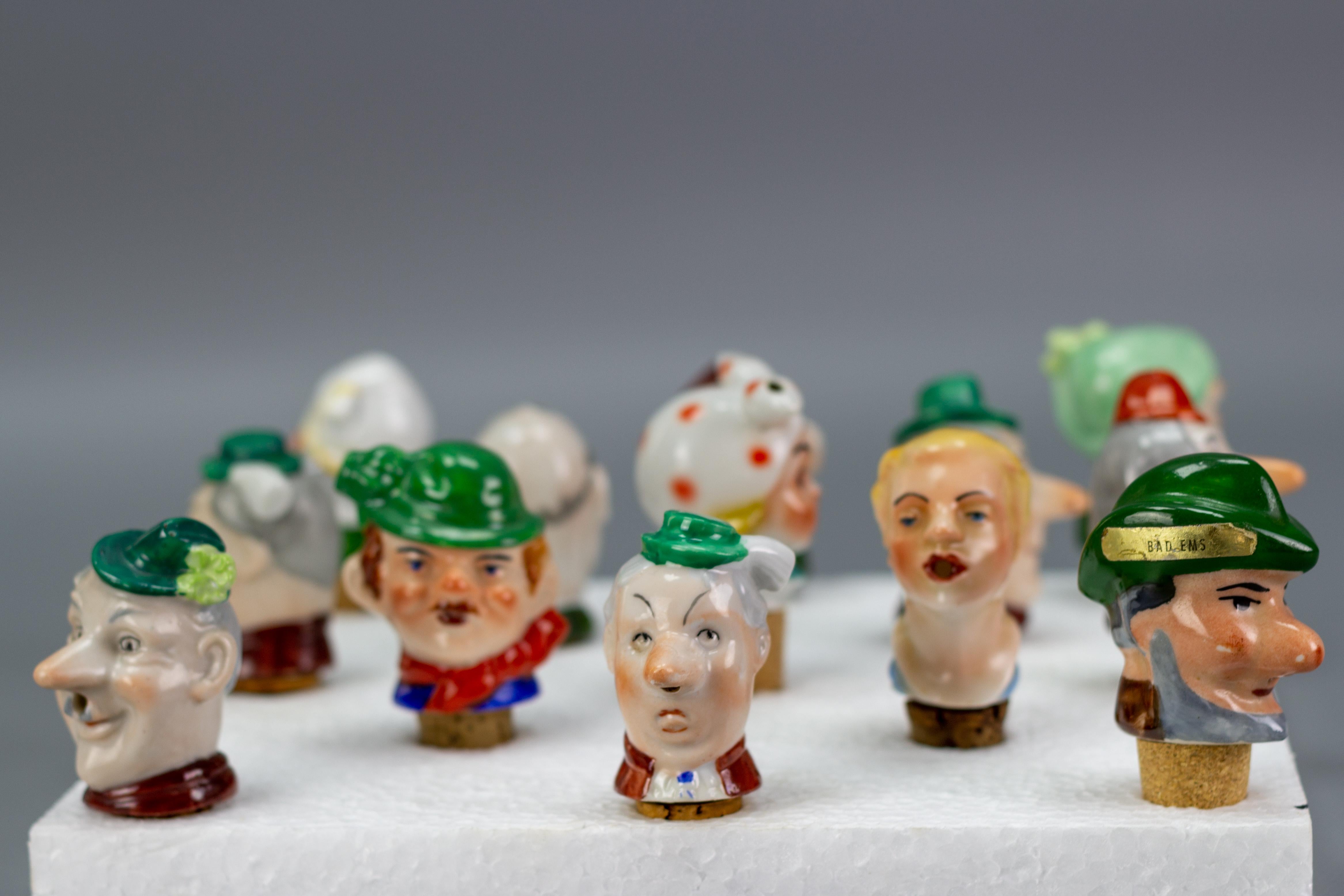 Mid-20th Century Set of 13 German Figural Porcelain and Cork Pourers Bottle Stoppers, 1930s For Sale