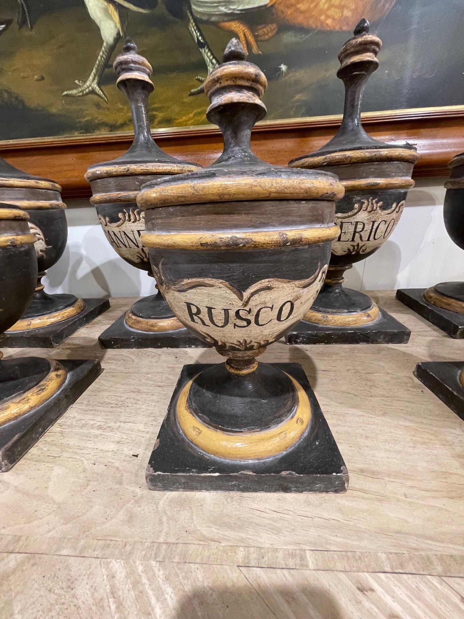 Interesting set of 13 Italian pottery pharmacy urns in various sizes. Painted in black and gold along with elegant writing. Makes a fabulous and unique accessory! Note largest is 18h x 18w.