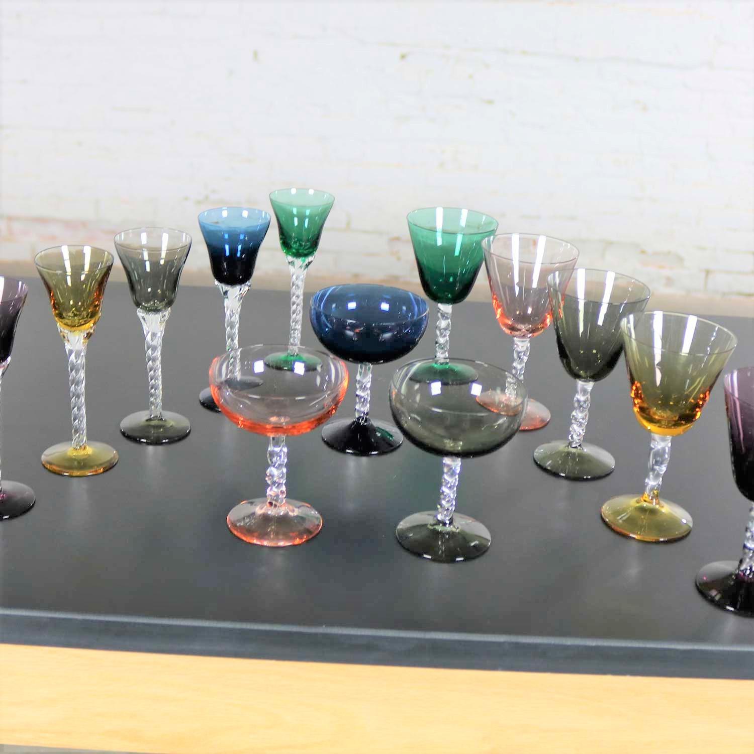 Incredible set of 13 pieces of multi-color stemware consisting of three sizes, three wine coupes, five small wines, and five liqueur or cordials. There are six different beautiful colors. They are in wonderful vintage condition with no chips,