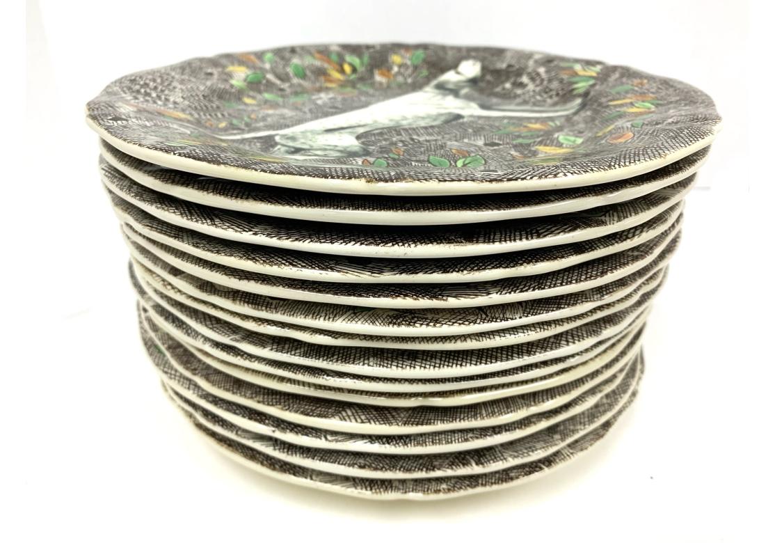 Set of 13 Rambouillet pattern by Faiencerie de Gien hunt luncheon plates with various dogs and game scenes on a brown leafy background. The plates include:

(3) Pheasant
(2) Labrador
(1) Setter
(3) Bassett
(2) Spaniel
(2) Pointer

Dimensions: 9