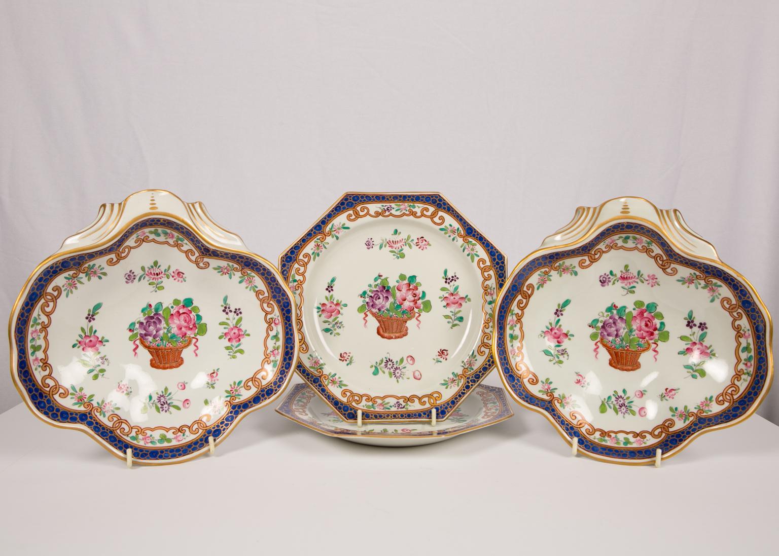 A set of 14 antique French porcelain dishes made in the last quarter of the 19th century circa 1870-1880. Attributed to the factory of Edme Samson.
The set contains 12 octagonal dishes, and two shell-shaped serving bowls. They are decorated in the