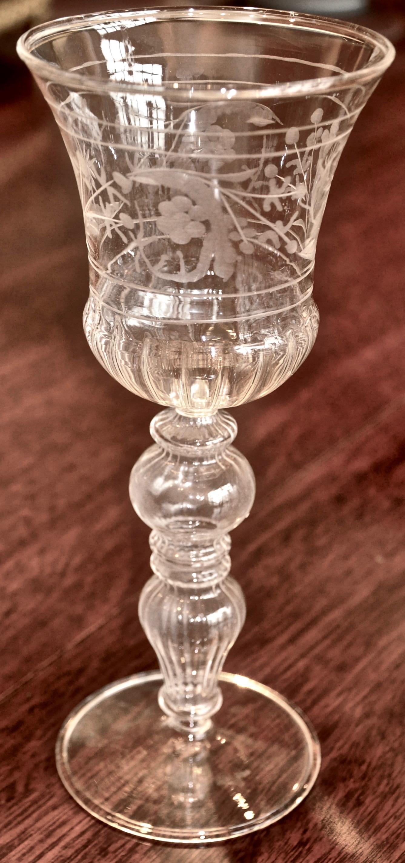 Fourteen Venetian glass wine goblets with floral etching. Hollow stem blown in Baroque manner of the 18th century. Footed base. Ribbed bowl. All in excellent.

From a Malibu collection.