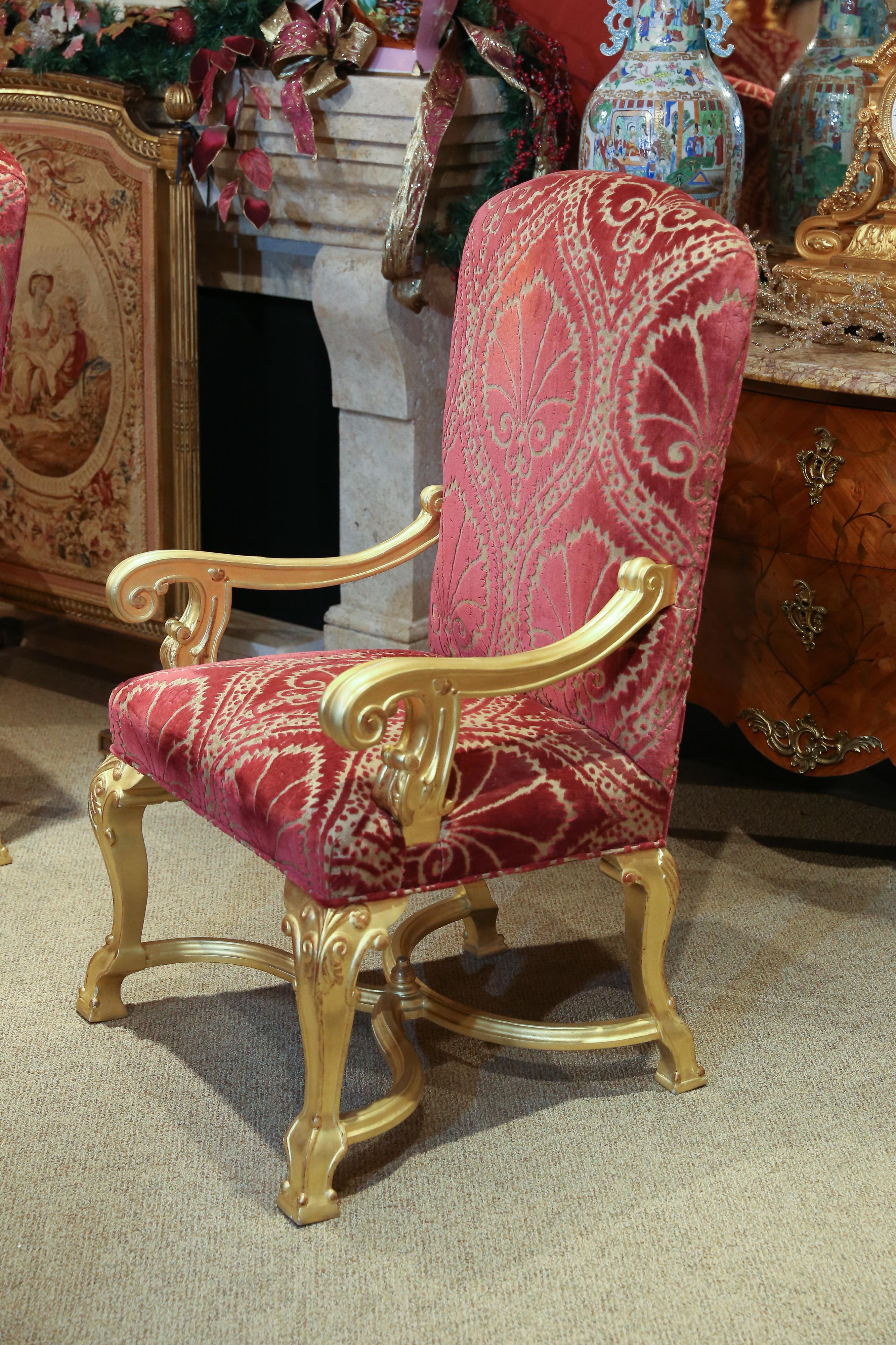 Incredible set of 14 dining chairs in giltwood. Upholstered with Clarence
house cut velvet fabric.
