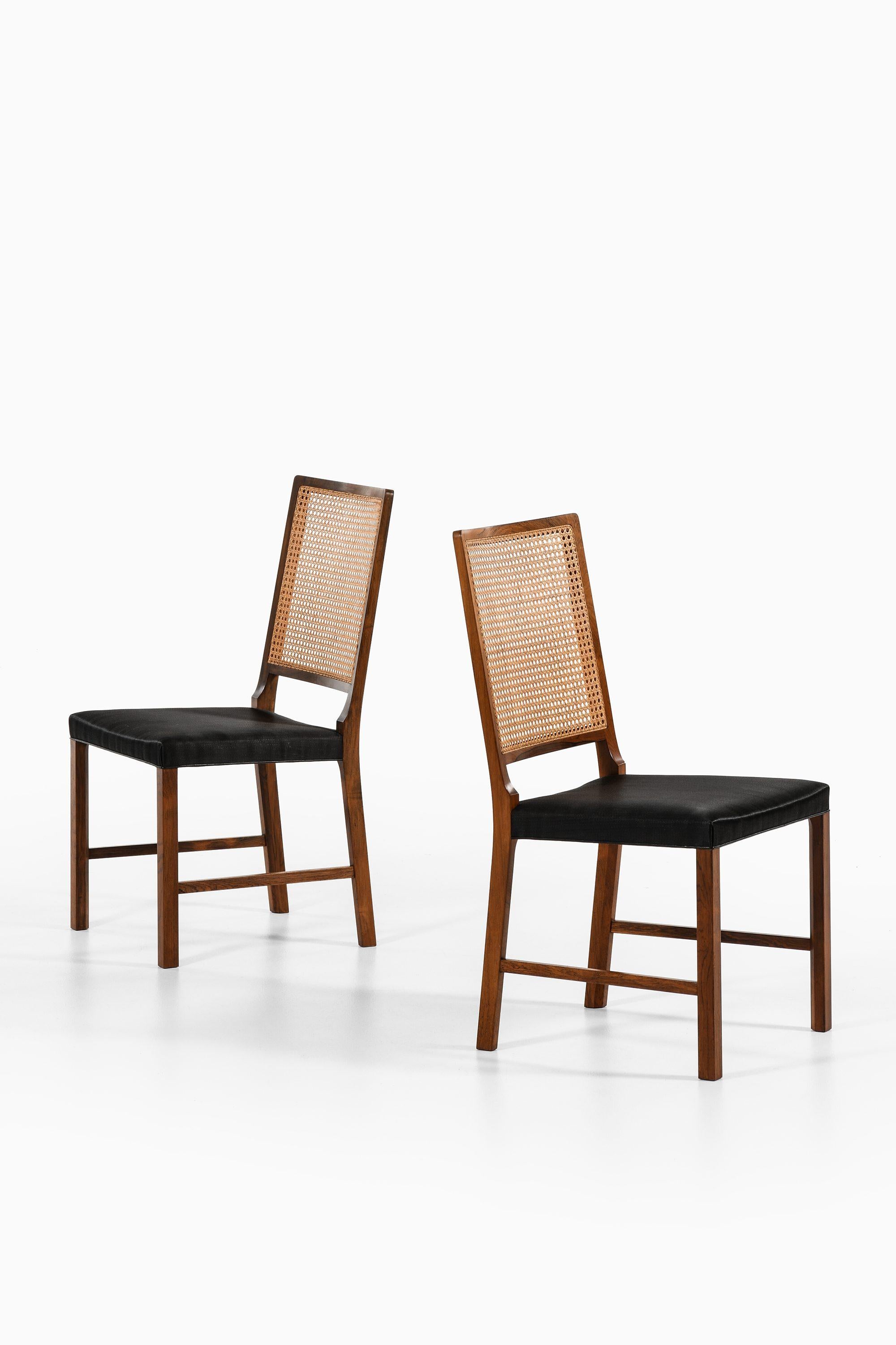 Scandinavian Modern Set of 14 Dining Chairs in Rosewood and Cane by Bernt Petersen, 1960's For Sale