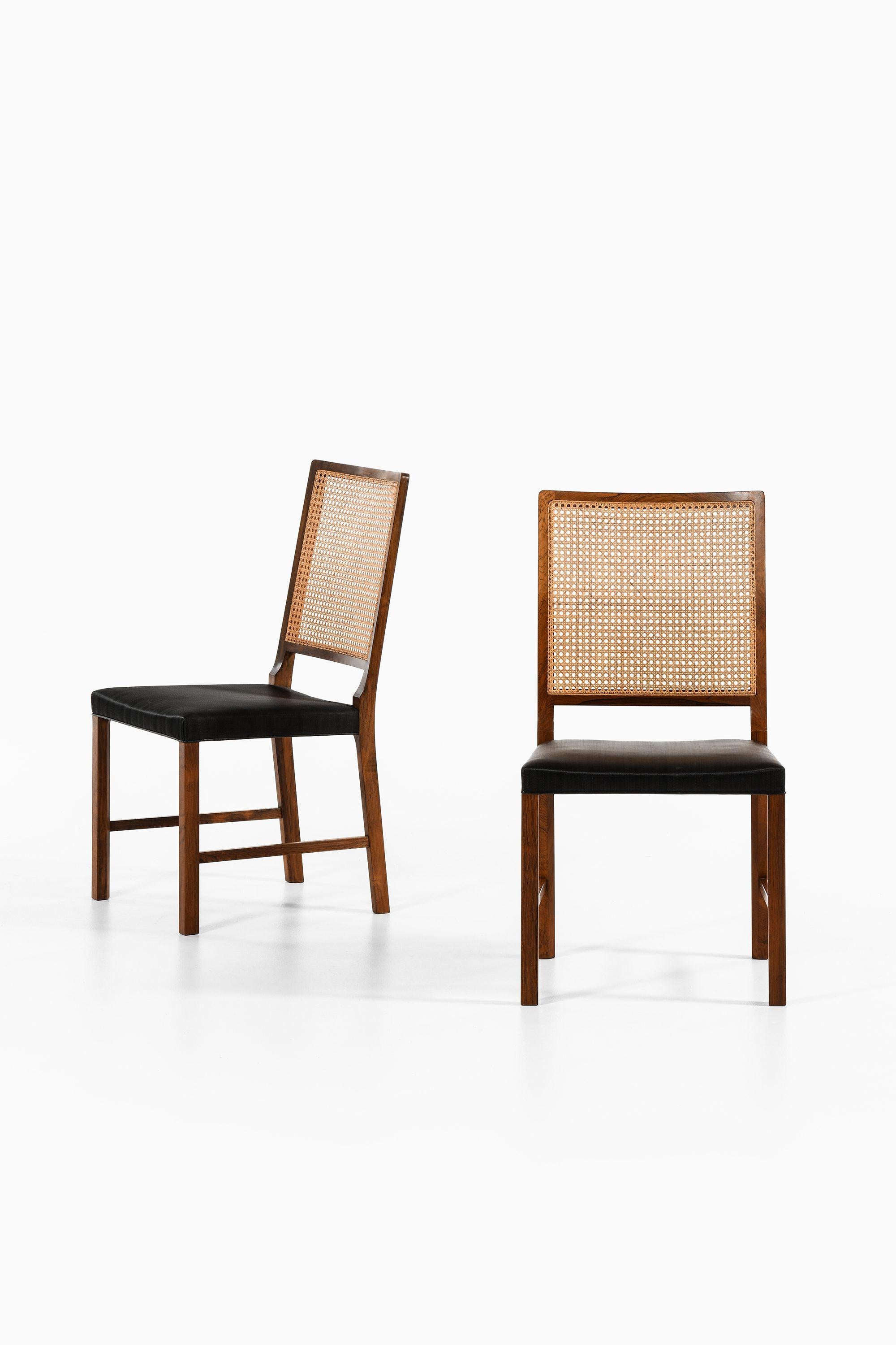 Danish Set of 14 Dining Chairs in Rosewood and Cane by Bernt Petersen, 1960's For Sale