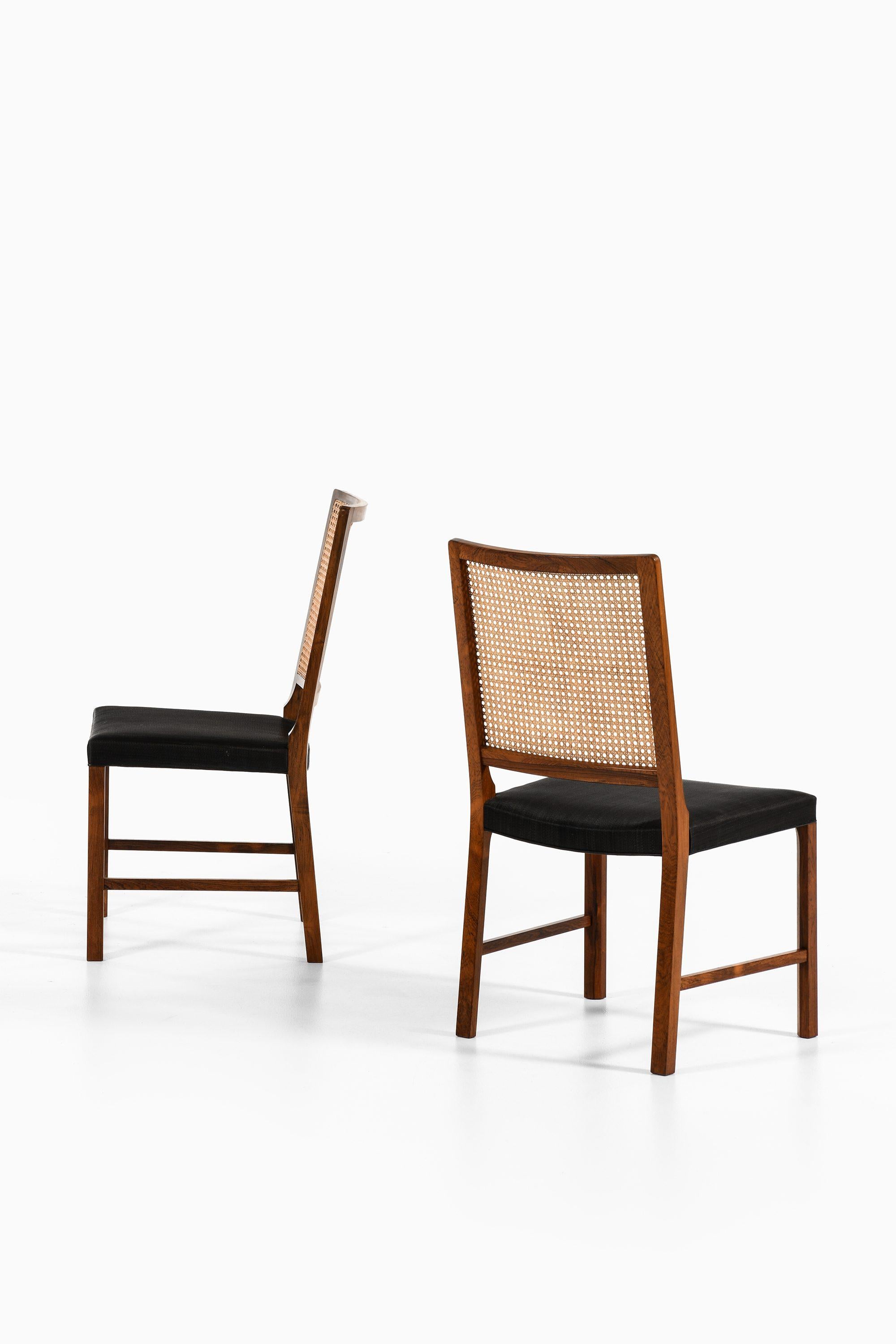 Set of 14 Dining Chairs in Rosewood and Cane by Bernt Petersen, 1960's In Good Condition For Sale In Limhamn, Skåne län