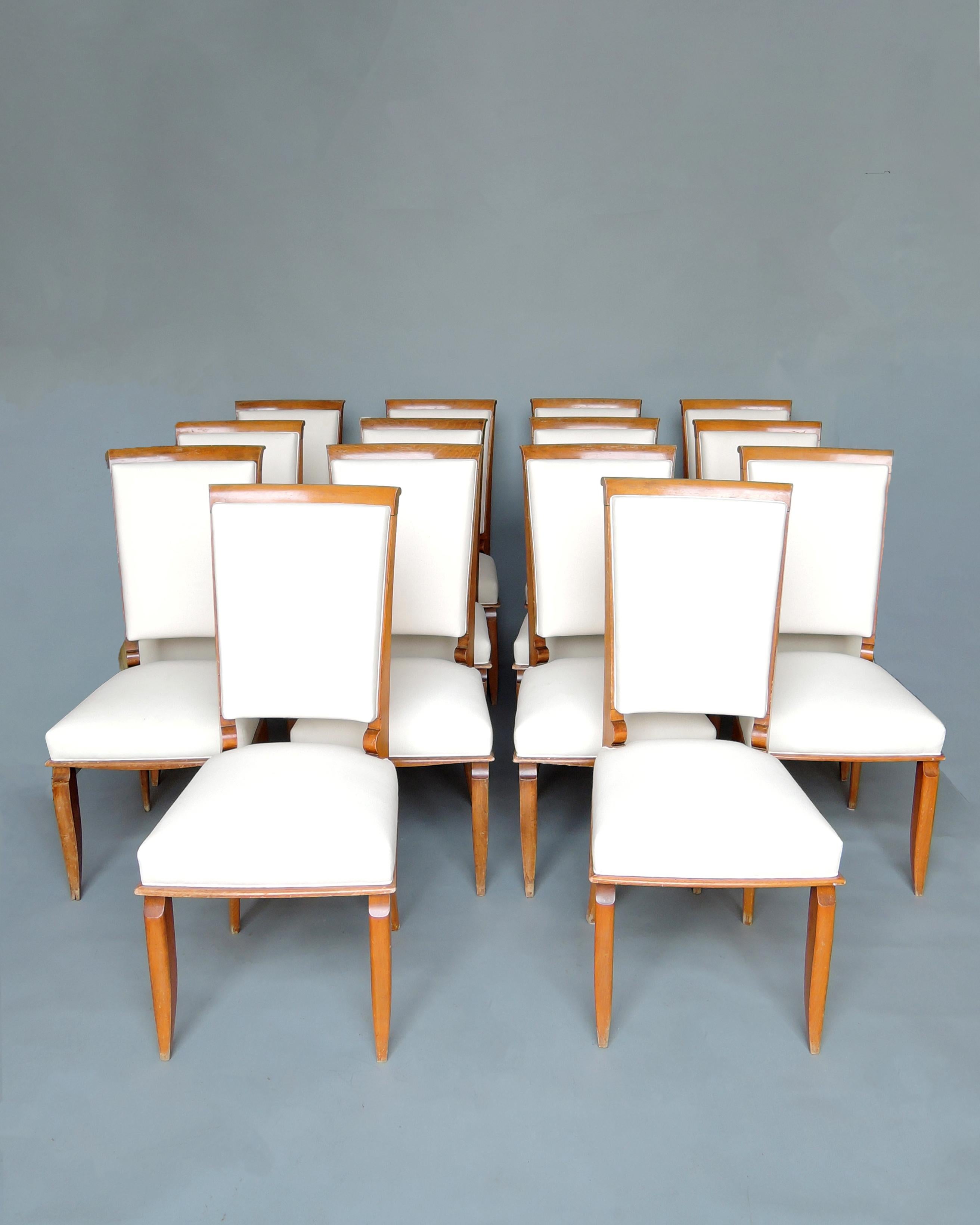 A set of fourteen fine French Art Deco solid beech side chairs in the manner of Jallot