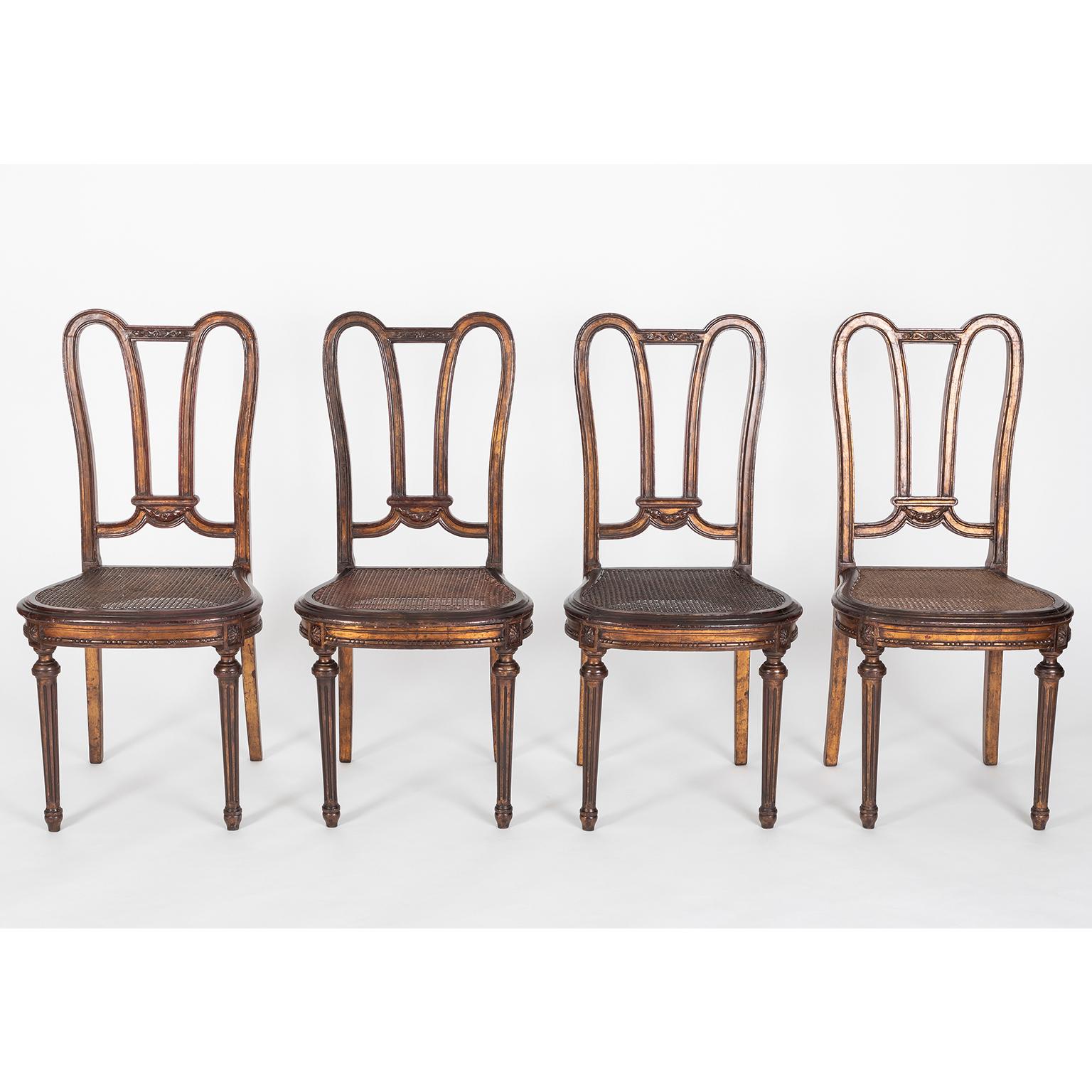 A set of fourteen Louis XVI style dining chairs in carved painted wood with canned seats with a wonderful patina.
Made in France, early 20th century

Dimensions: Width 46 cm; depth 45cm; total height 96 cm; seat height 45 cm.