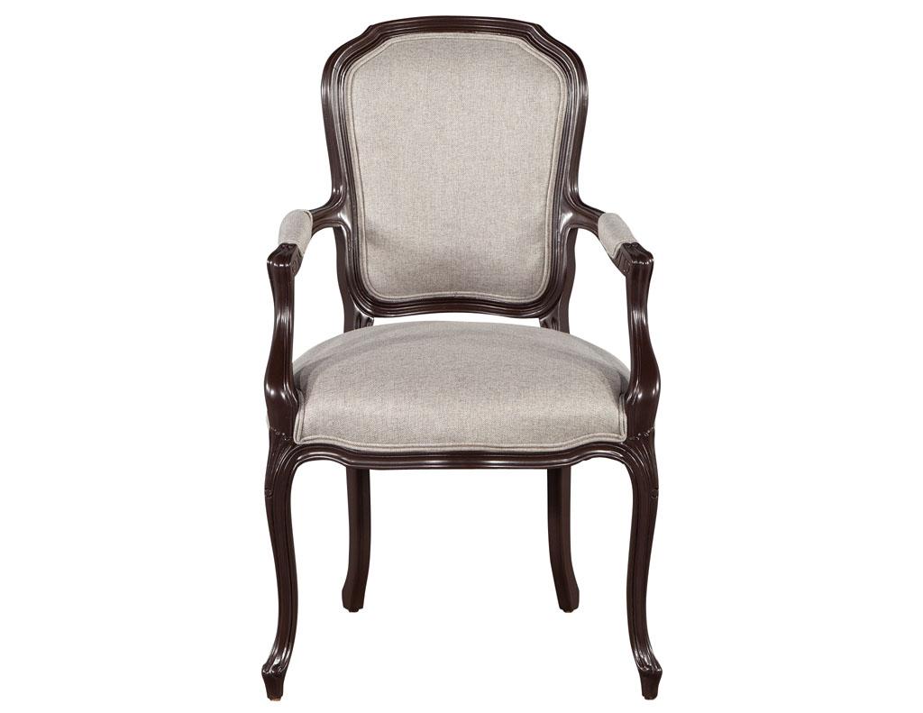 Set of 14 Louis XIV Style dining chairs in Solid Lacquer Finish. Italy, circa 1970’s, restored in a rich Benjamin Moore black bean soup satin lacquer finish. Upholstered in champagne textured fabric with a luxurious shimmering sheen. Set includes 12