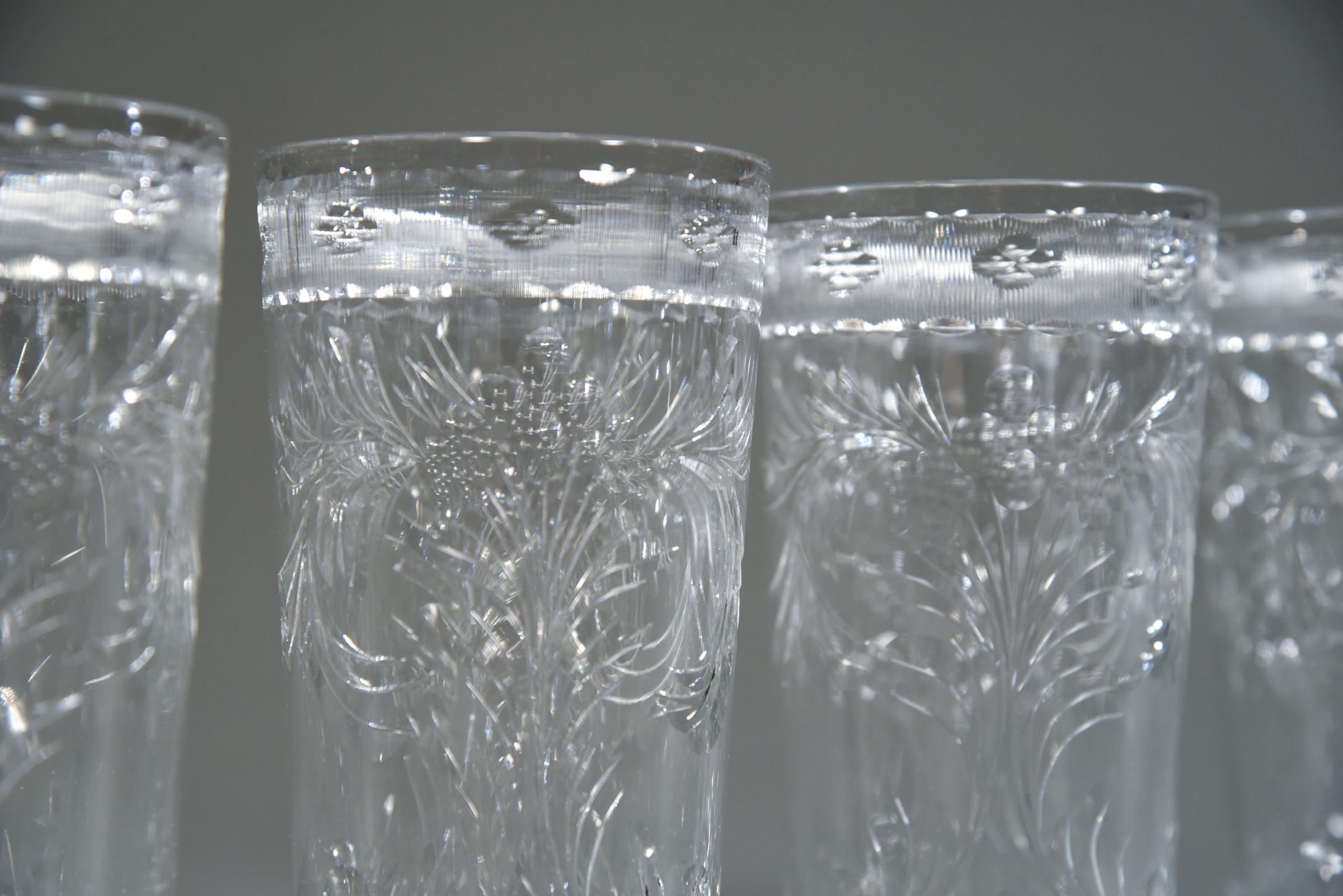 This set of 14 (12 pictured) was made and signed by T. G. Hawkes, Corning NY and they feature a wonderfully large size and beautifully cut decoration. The clear crystal is decorated with wheel cut engraving and topped with a vertically cut border.