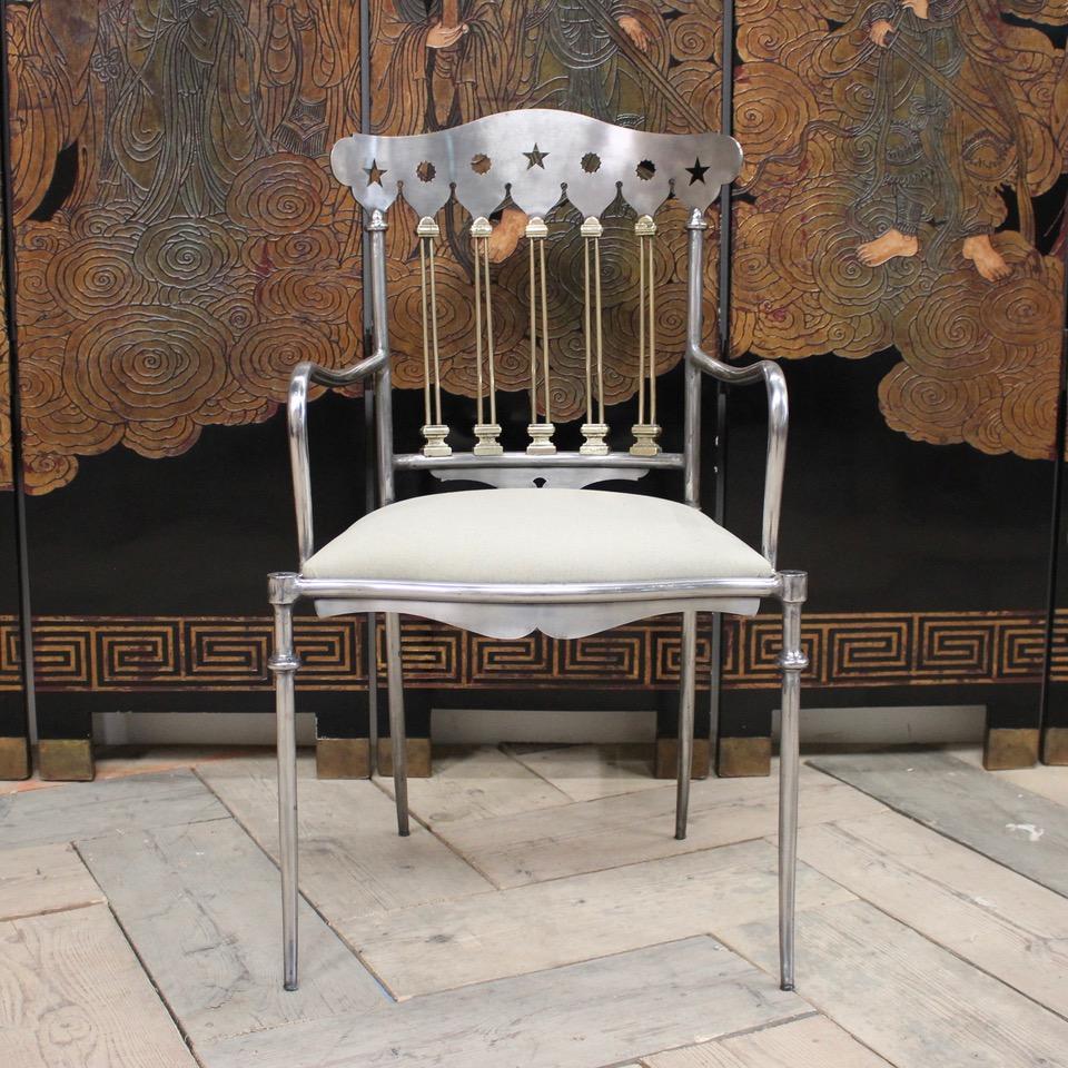 An outstanding set of 14, mid-20th century Spanish dining chairs in polished steel and brass, with great detail, and very comfortable that will make a statement in most settings. The seats reupholstered in a neutral linen. Priced at £ 450 each