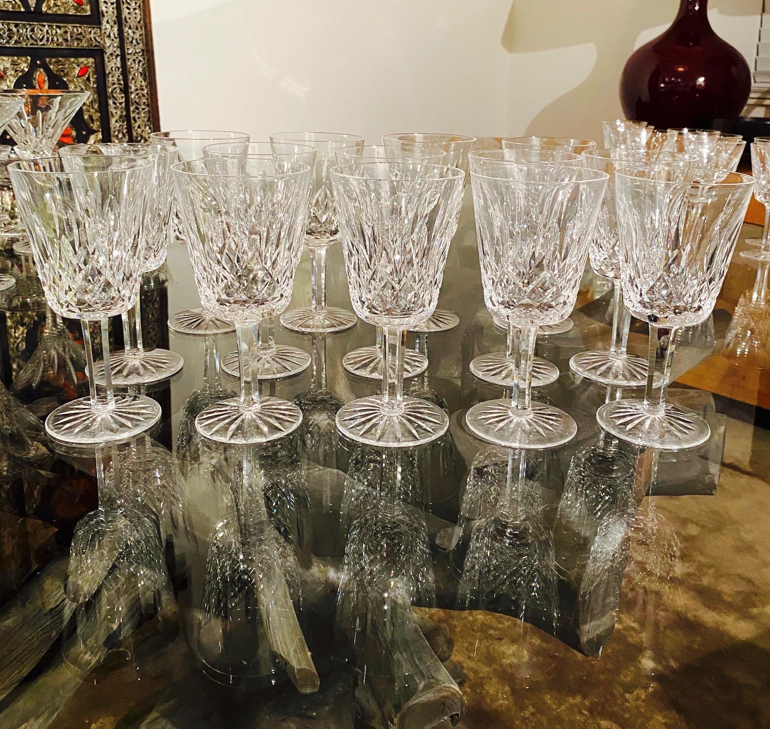Set of fourteen luxury crystal water goblets from Waterford Crystal. The Lismore Collection is perhaps Waterford's most distinguished design featuring hand blown crystal with the pattern's signature diamond and wedge cuts. First introduced in the