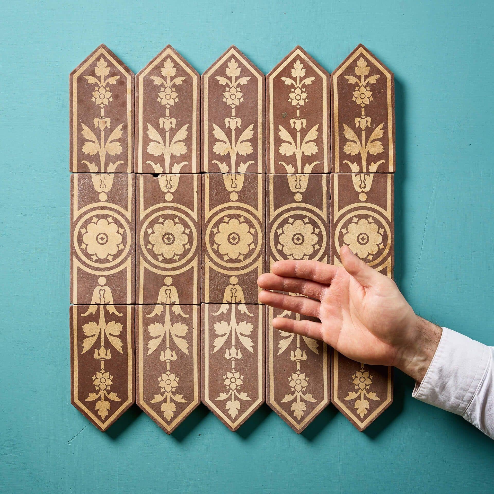 A  set of 15 encaustic tiles with floral design in buff and brown tones by Campbell Tile Co (stamped); one of several sets of matching tiles we are selling in groups of fifteen as pictured.

This very unusual set comprises of 5 rectangular tiles
