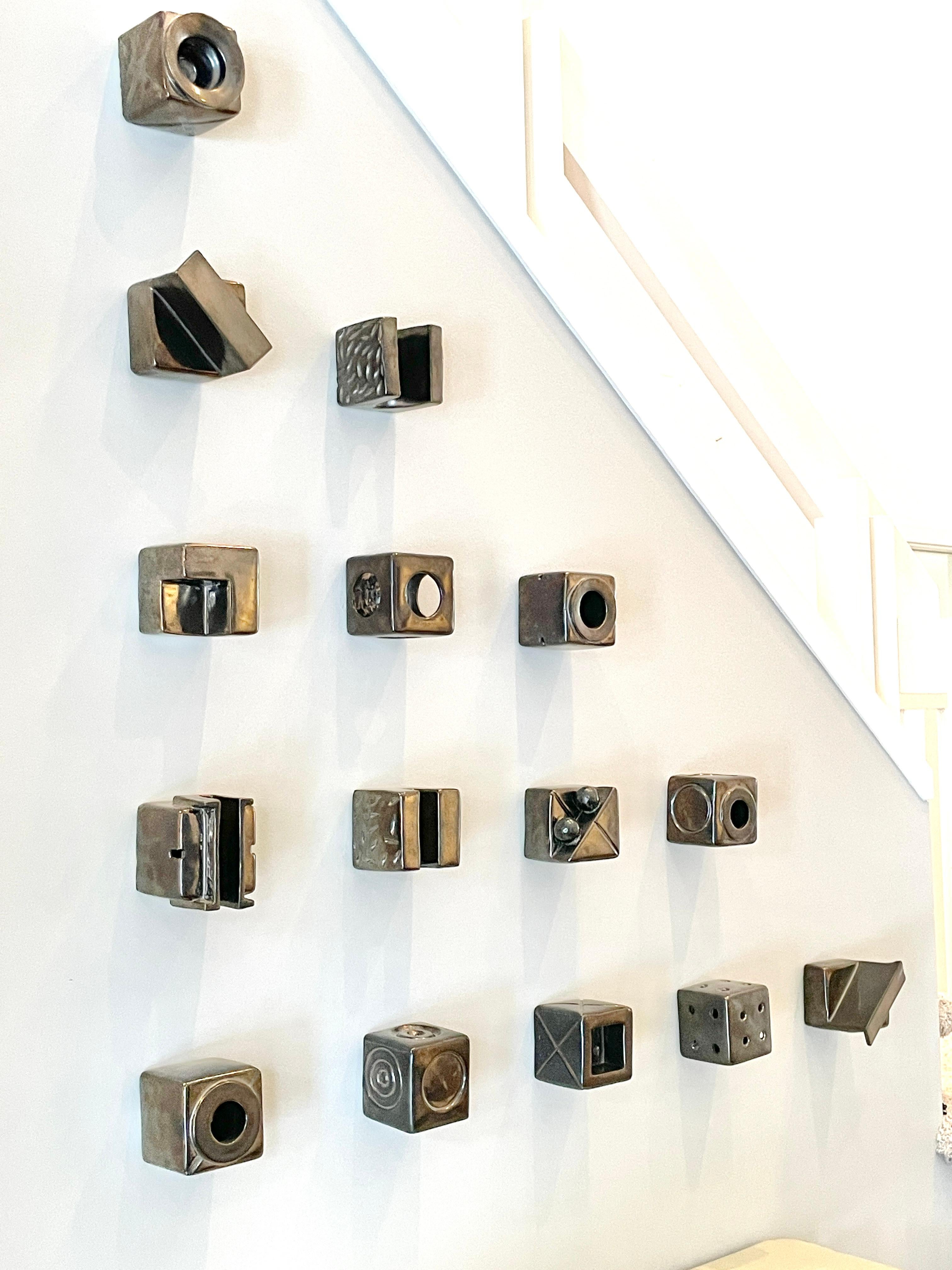 Kaiser Suidan Ceramic Cubes Modern Art Wall Sculpture 15 pieces

Collection of 15 cube sculptures by Michigan artist Kaiser Suidan
Various geometric forms in gun metal glaze
Wall mounted and signed to back
Suidan's cube series dates back to the