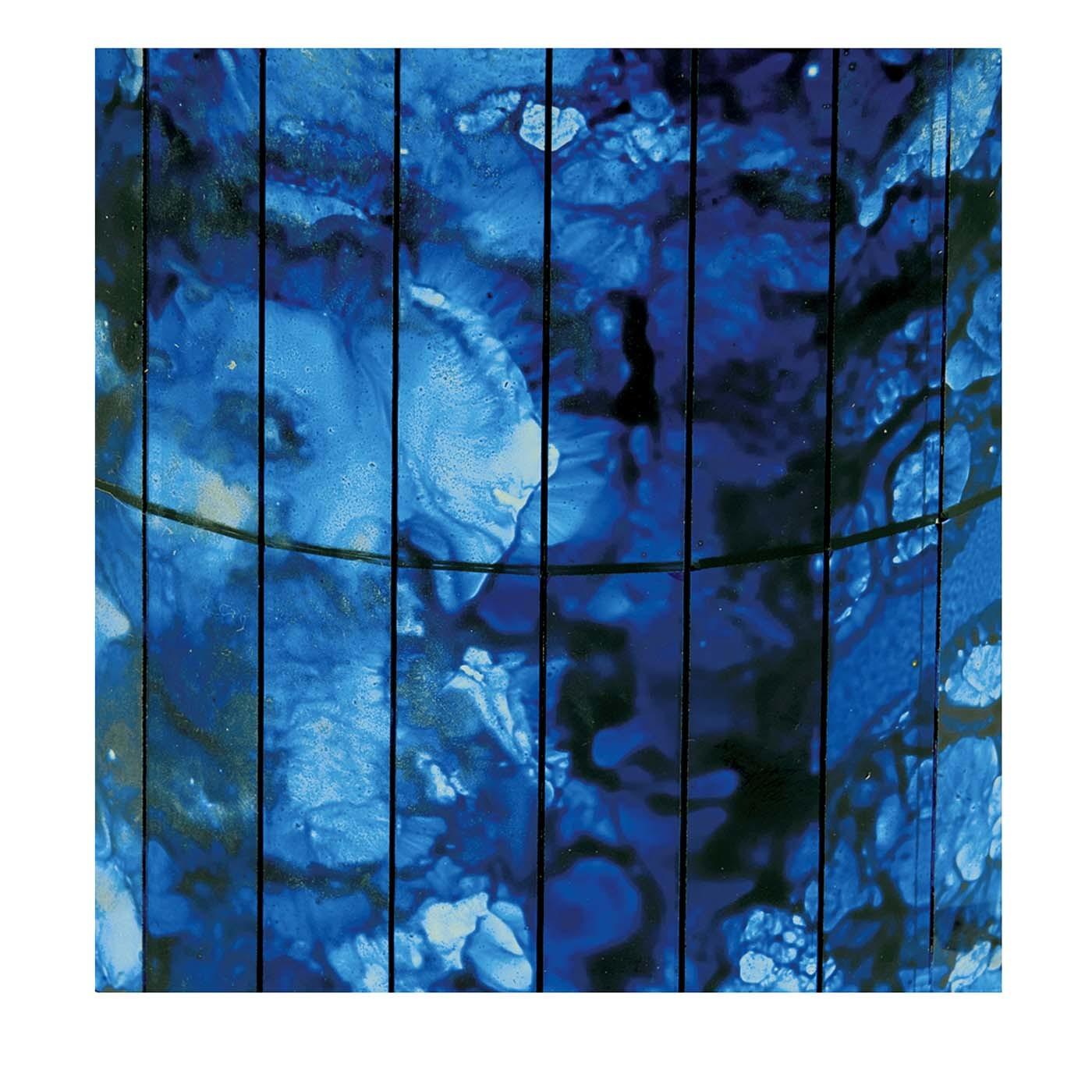 The mesmerizing and deep tones of blue on this set of canvased mosaic glass panels are a moving interplay between the blue bounty of earth's gems and the rich swirls of the ocean. This stunning decoration will add a profound mark to any modern or