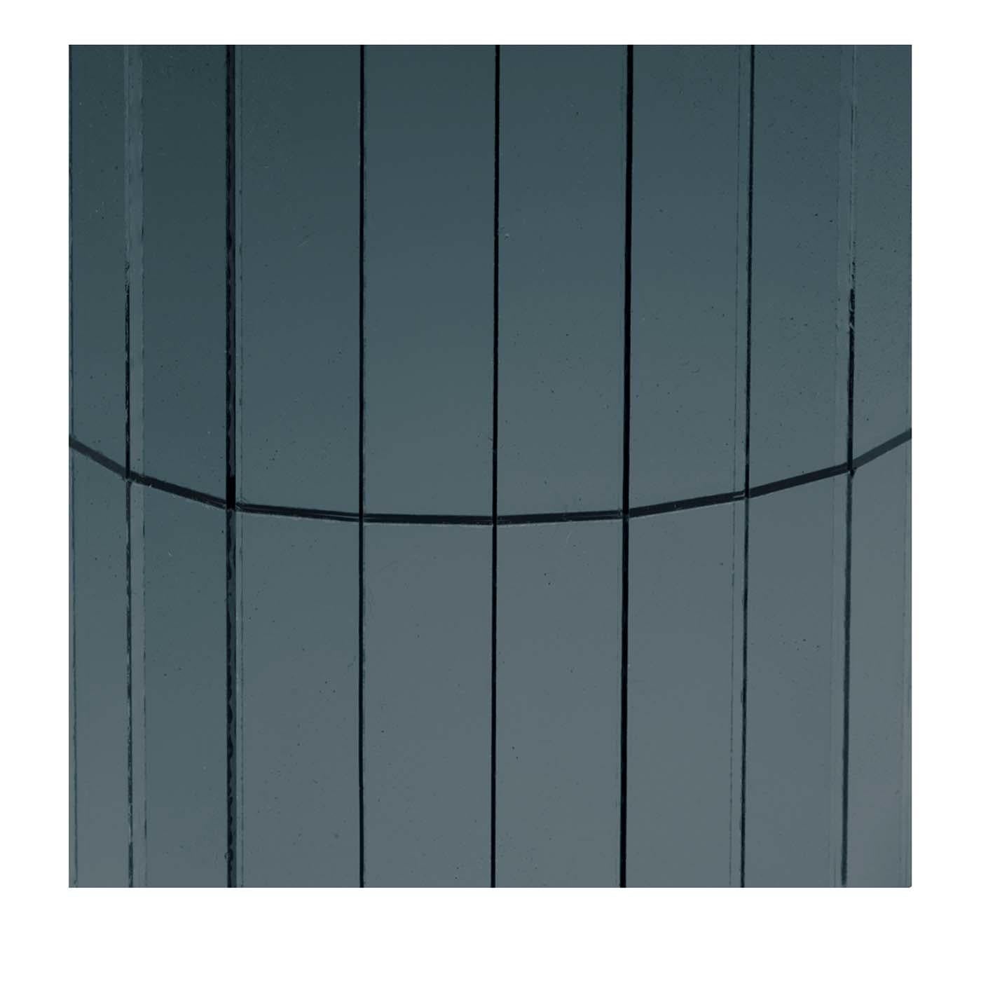 These smokey and dark glass mosaic panele by Antique Mirror makes for an austere and moody effect. This piece was crafted of 12.5 x 50 mm glass tiles attached on a canvas base to create a striking contrast against a light wall, or to provide a