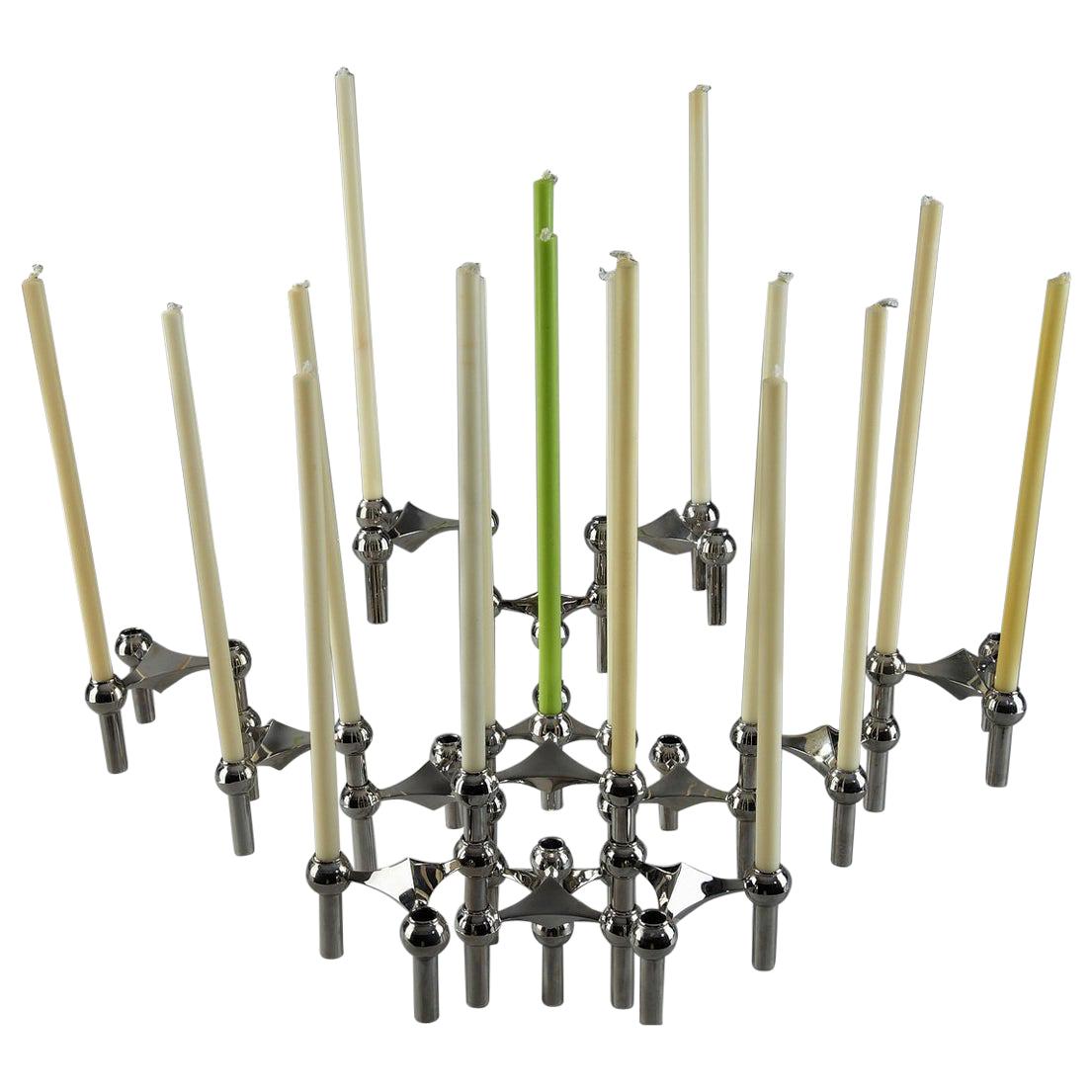Set of 15 modular chromed metal stackable S22 candle holders and PVC jardinière edited by Nagel in the 1970s. This modular design can be configured in an endless number of ways both vertically and horizontally by stacking each interlocking piece.
