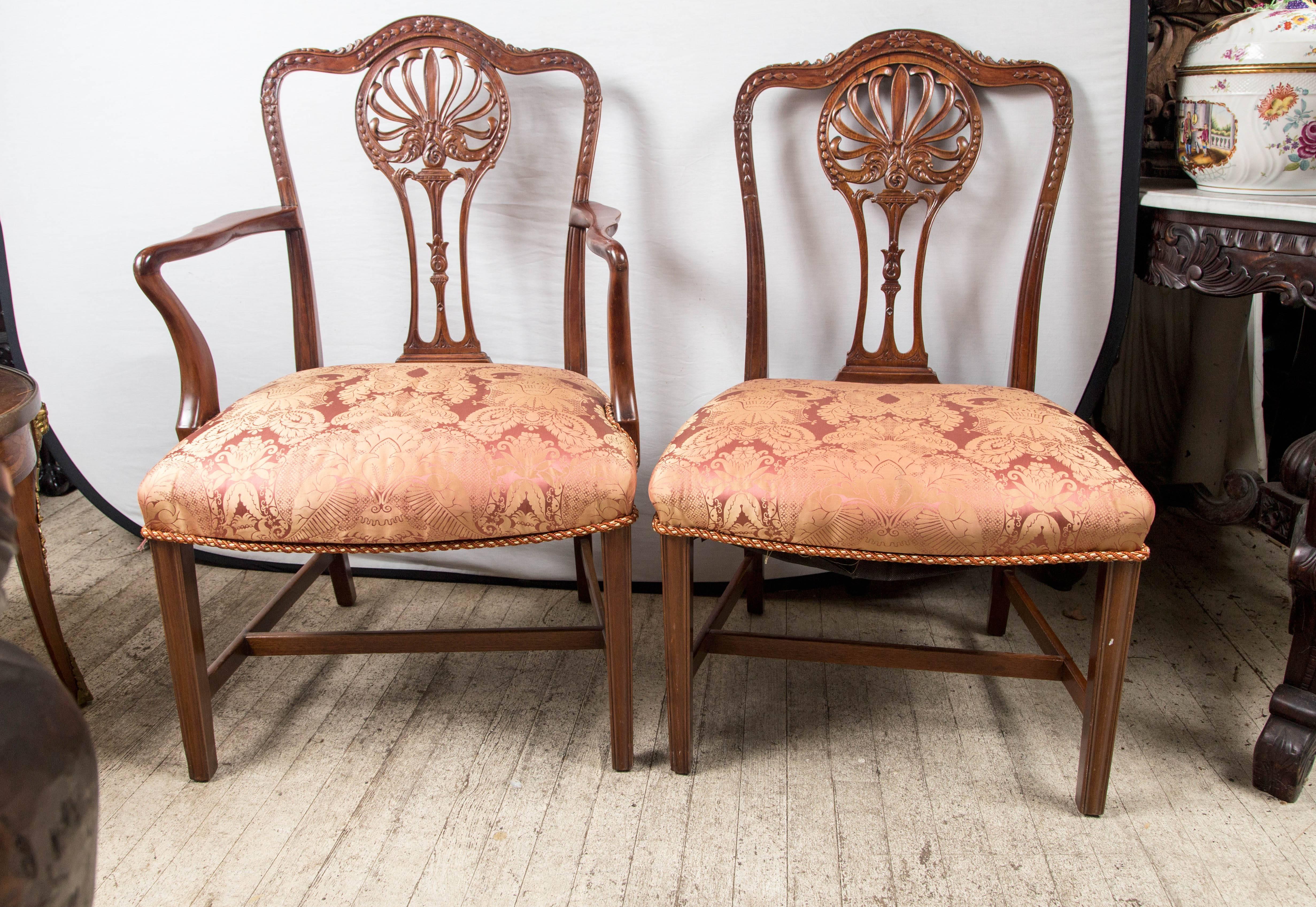 The set consists of two armchairs and 14 side chairs. The set can be split in half.

Light colored mahogany, newly upholstered. 

 