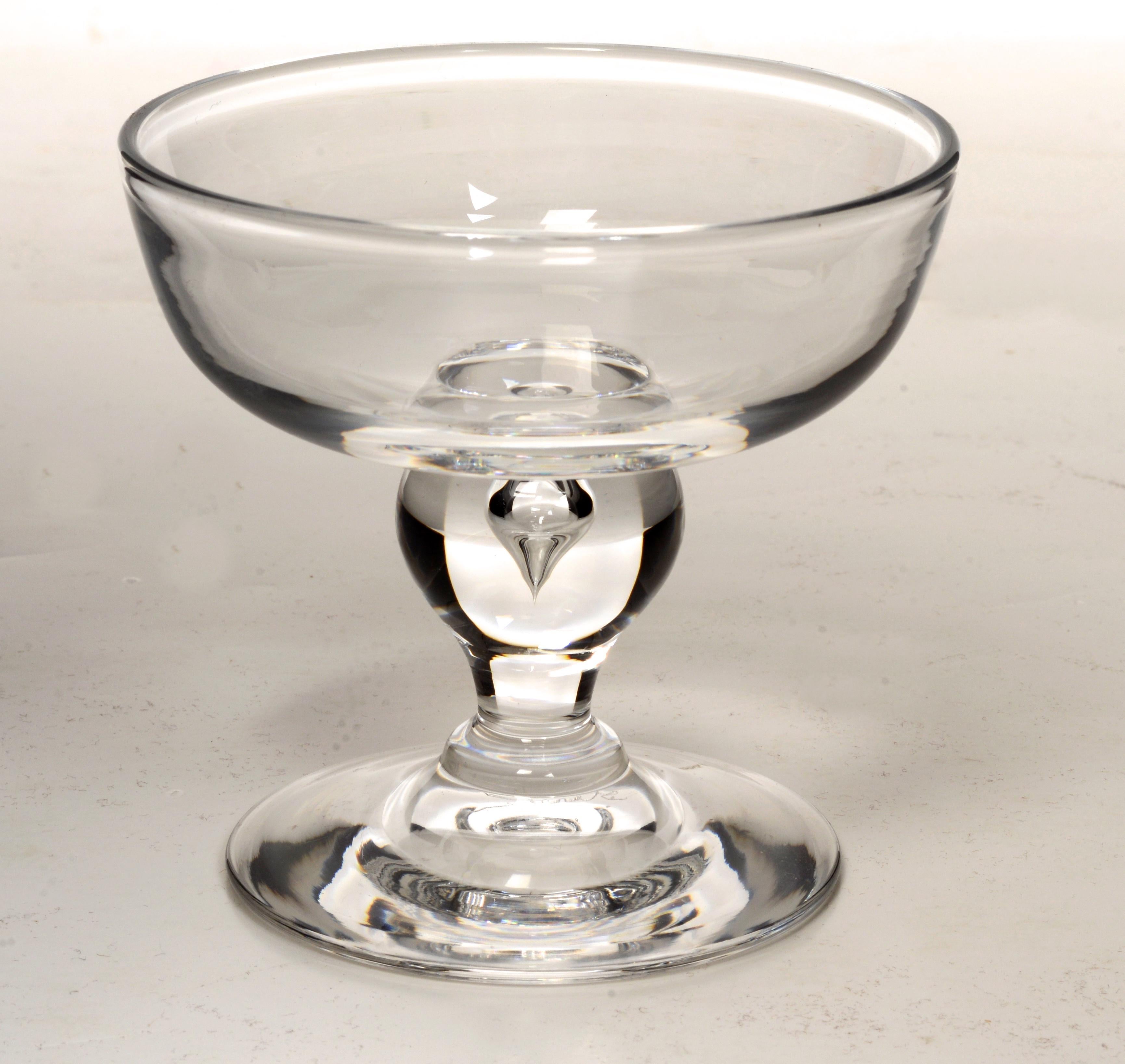 A Set of 16 George Thompson Designed Hand Blown Steuben Champagne/Coupe/Tall Sherbet Pattern #7877, Mid 20th c Glasses. Steuben glass is elegantly contemporary and flawlessly executed. Steuben is an offshoot of Corning Glass Works in Corning, N.Y.